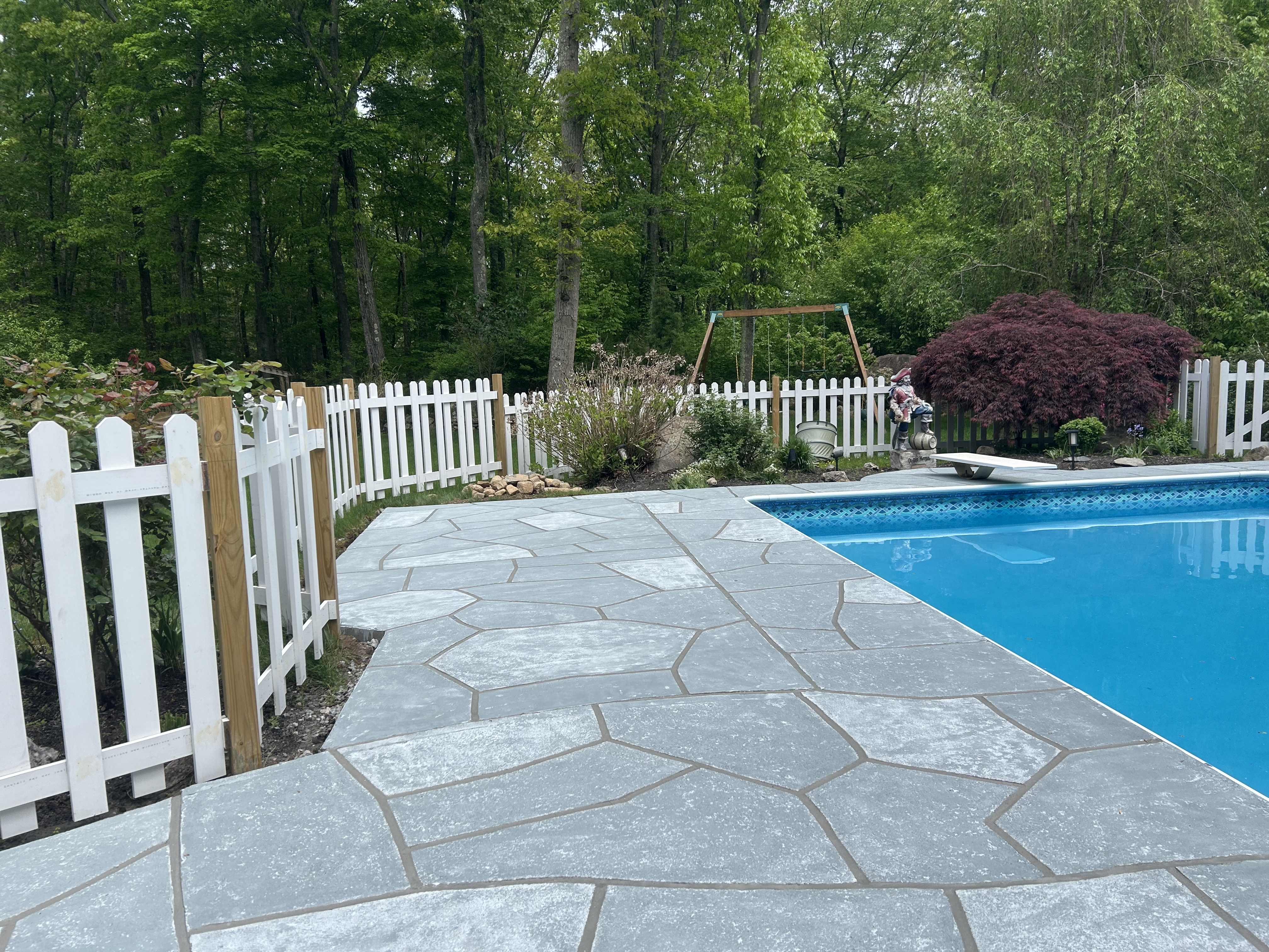 RenuKrete resurfaced pool deck in Granite Boulder showing rugged stone-like texture in Plymouth, MA