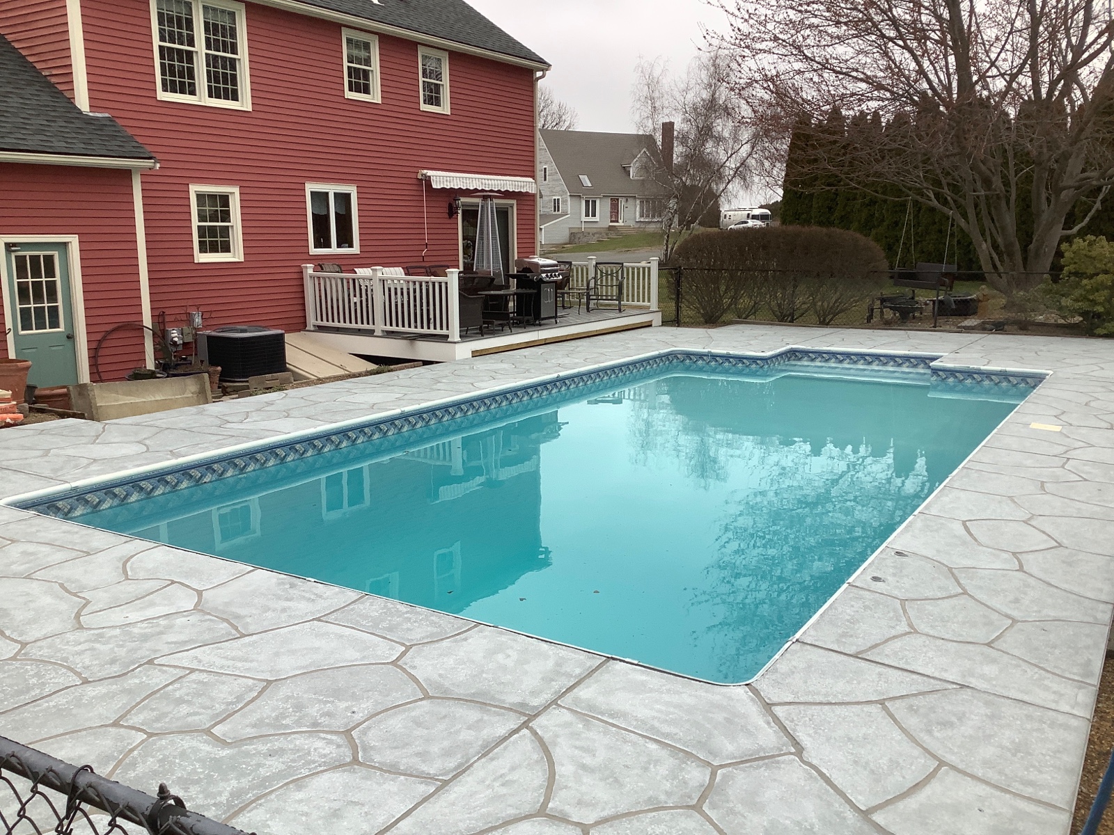 Pool deck resurfaced in Granite Boulder finish with textured stone surface