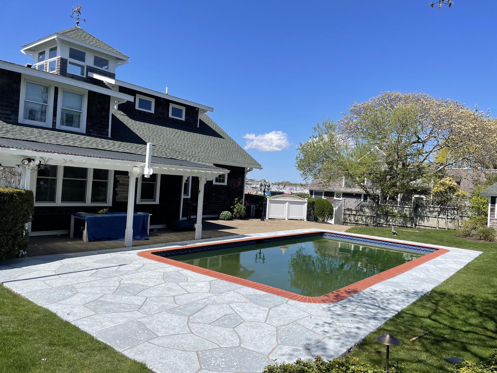 Pool deck resurfaced in Granite Boulder finish with textured stone surface in Stamford, CT