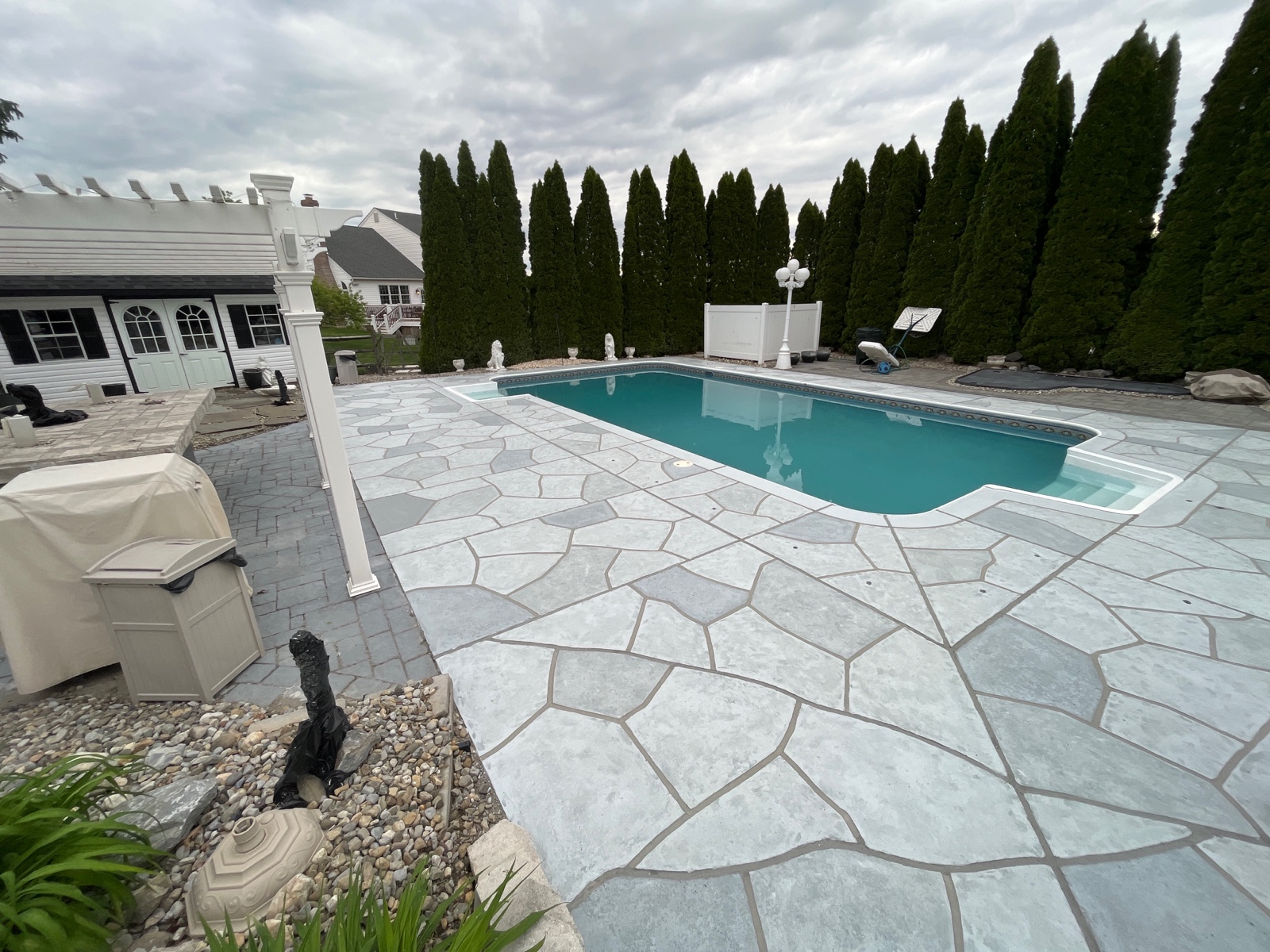 Pool deck resurfaced in Granite Boulder finish with durable resurfaced concrete in Rockville, MD