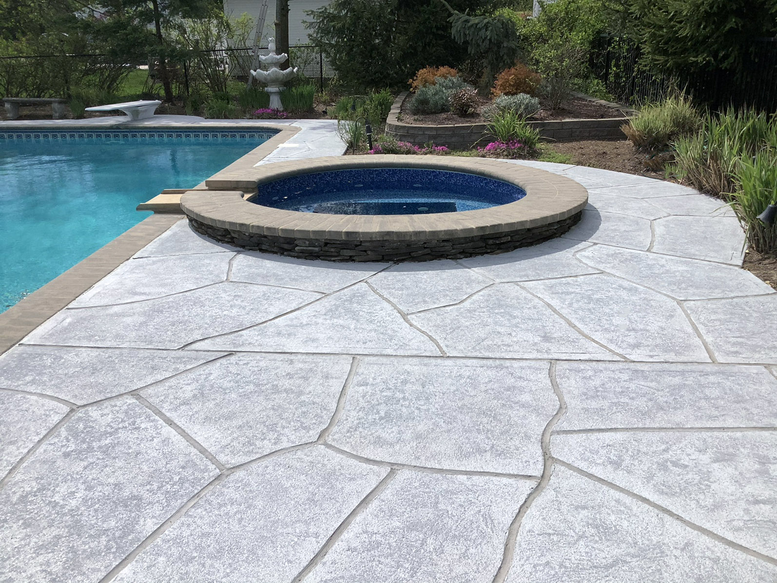 Granite Boulder pool deck renovation displaying deep gray granite tones