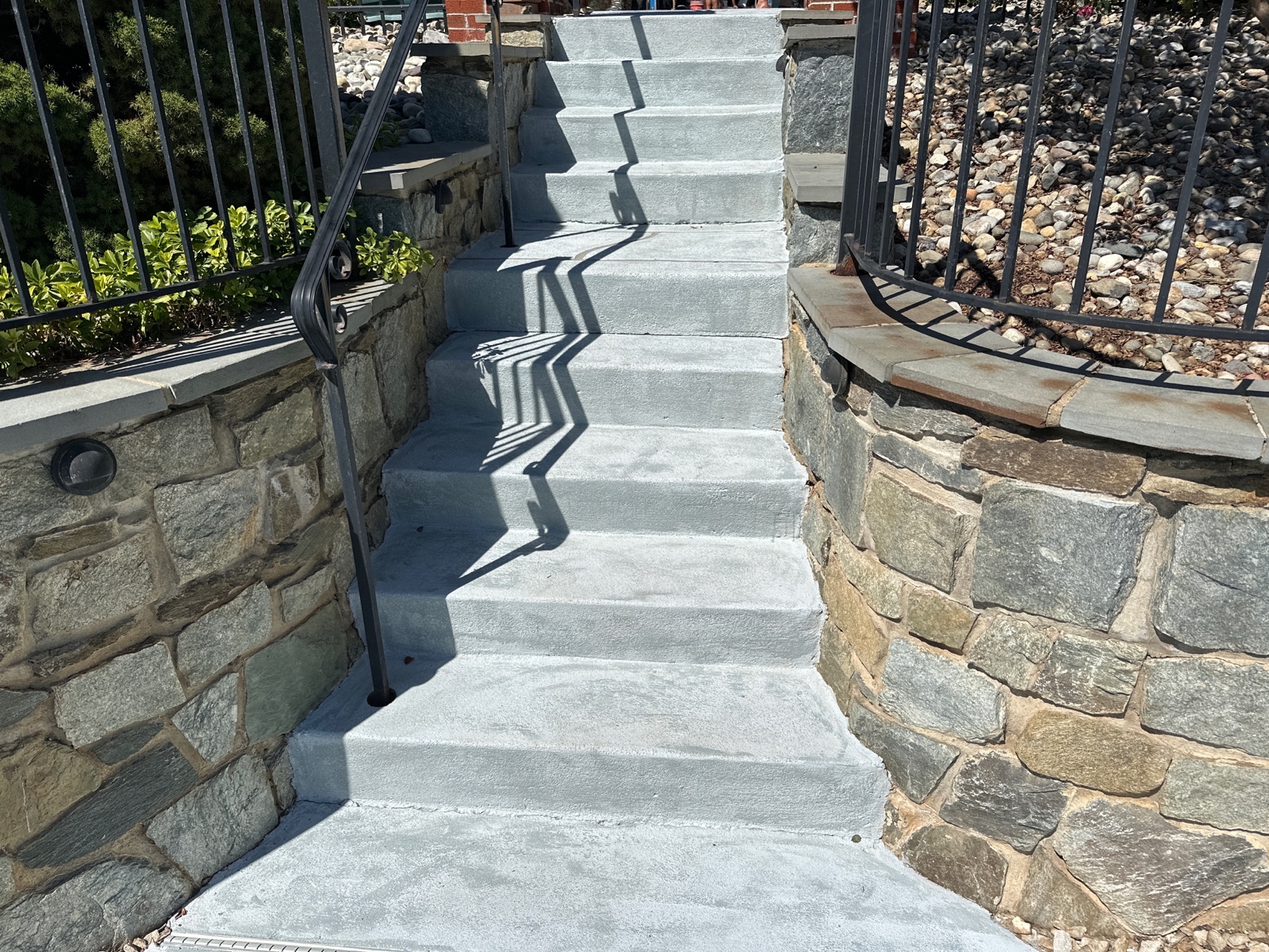 RenuKrete resurfaced pool deck in Granite Boulder showing rugged stone-like texture
