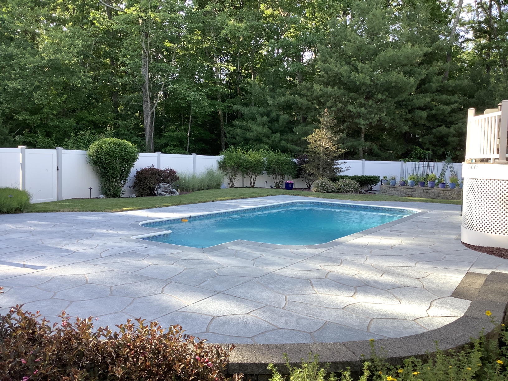 RenuKrete resurfaced pool deck in Granite Boulder showing textured stone surface