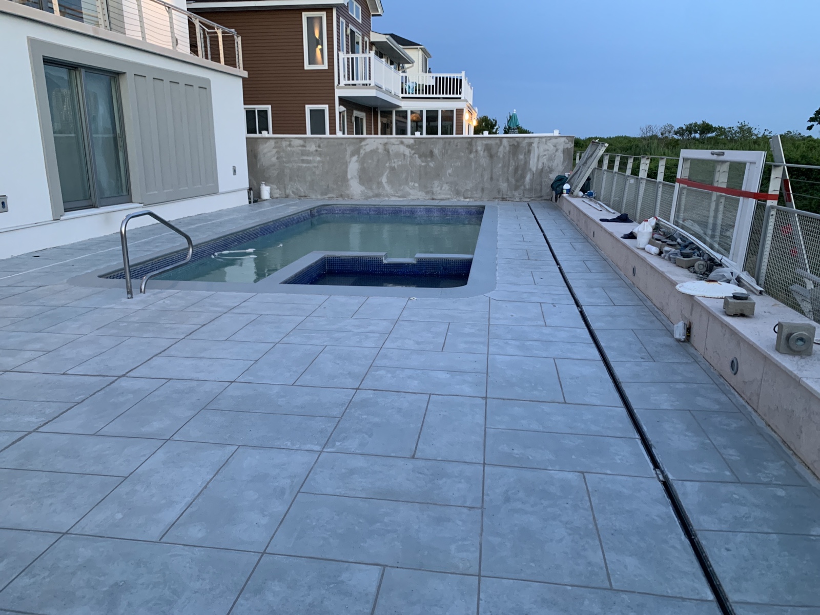 Pool deck renovation featuring Granite Boulder tile pattern concrete resurfacing