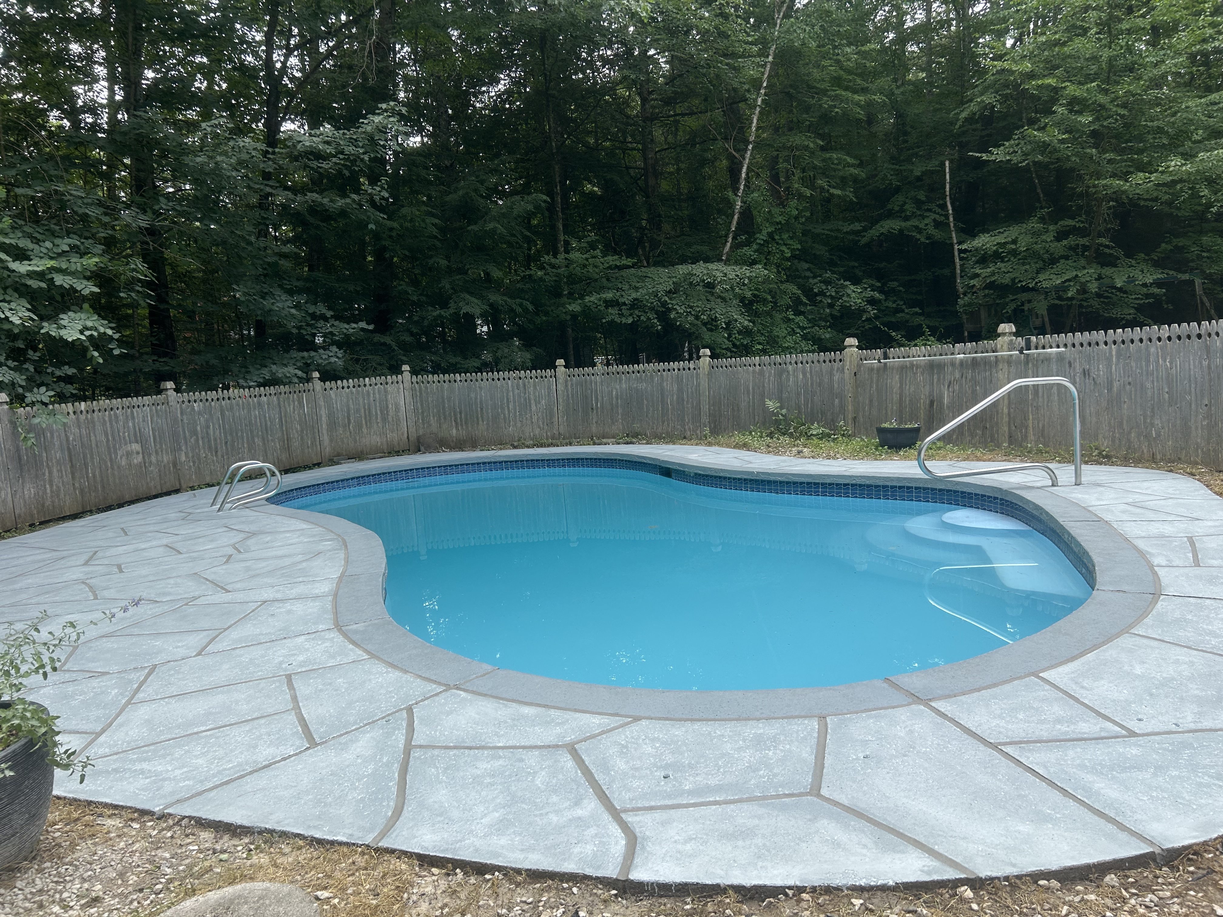 RenuKrete resurfaced pool deck in Granite Boulder showing textured stone surface