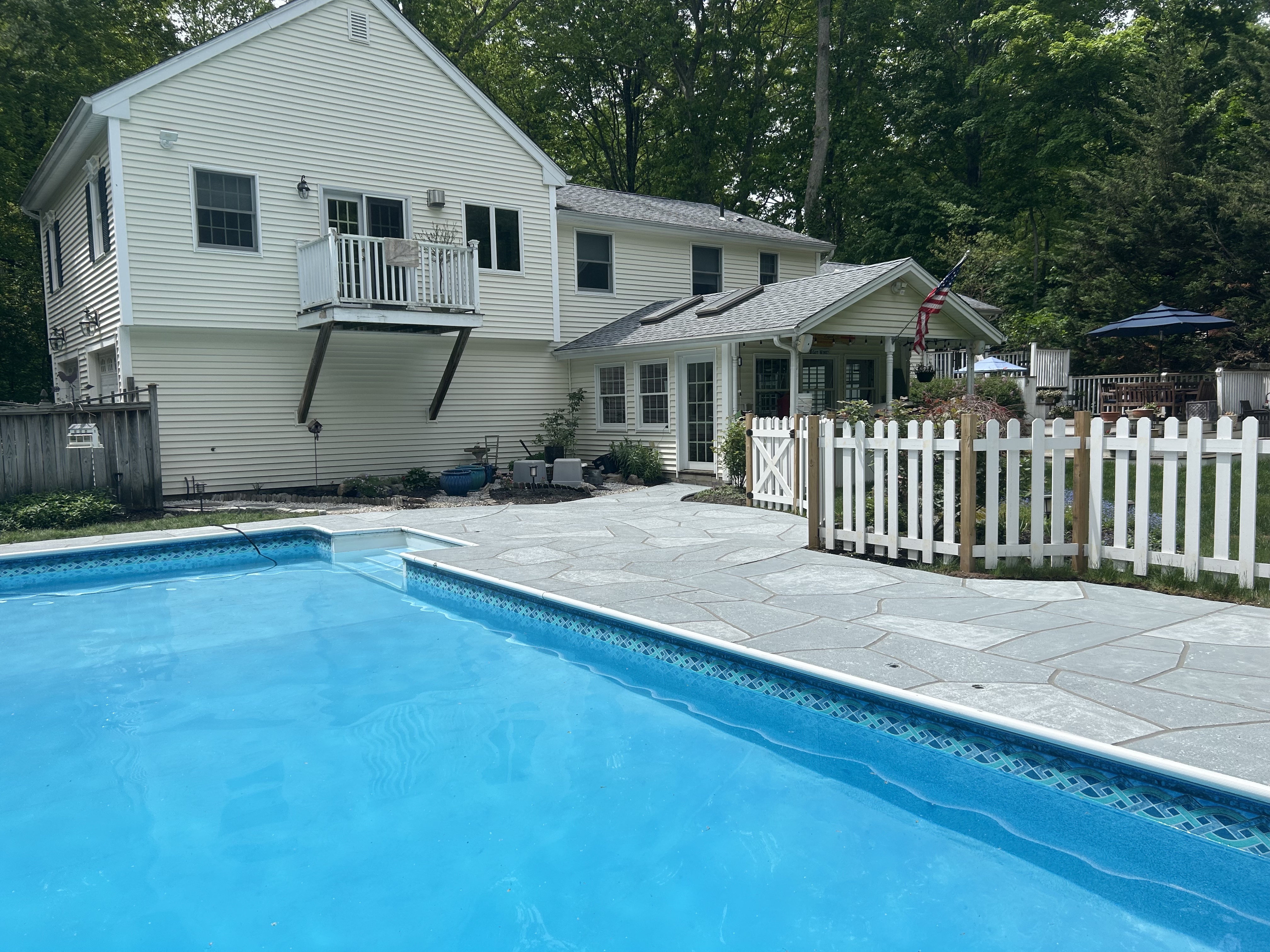 Granite Boulder pool deck renovation displaying durable resurfaced concrete in Summit, NJ