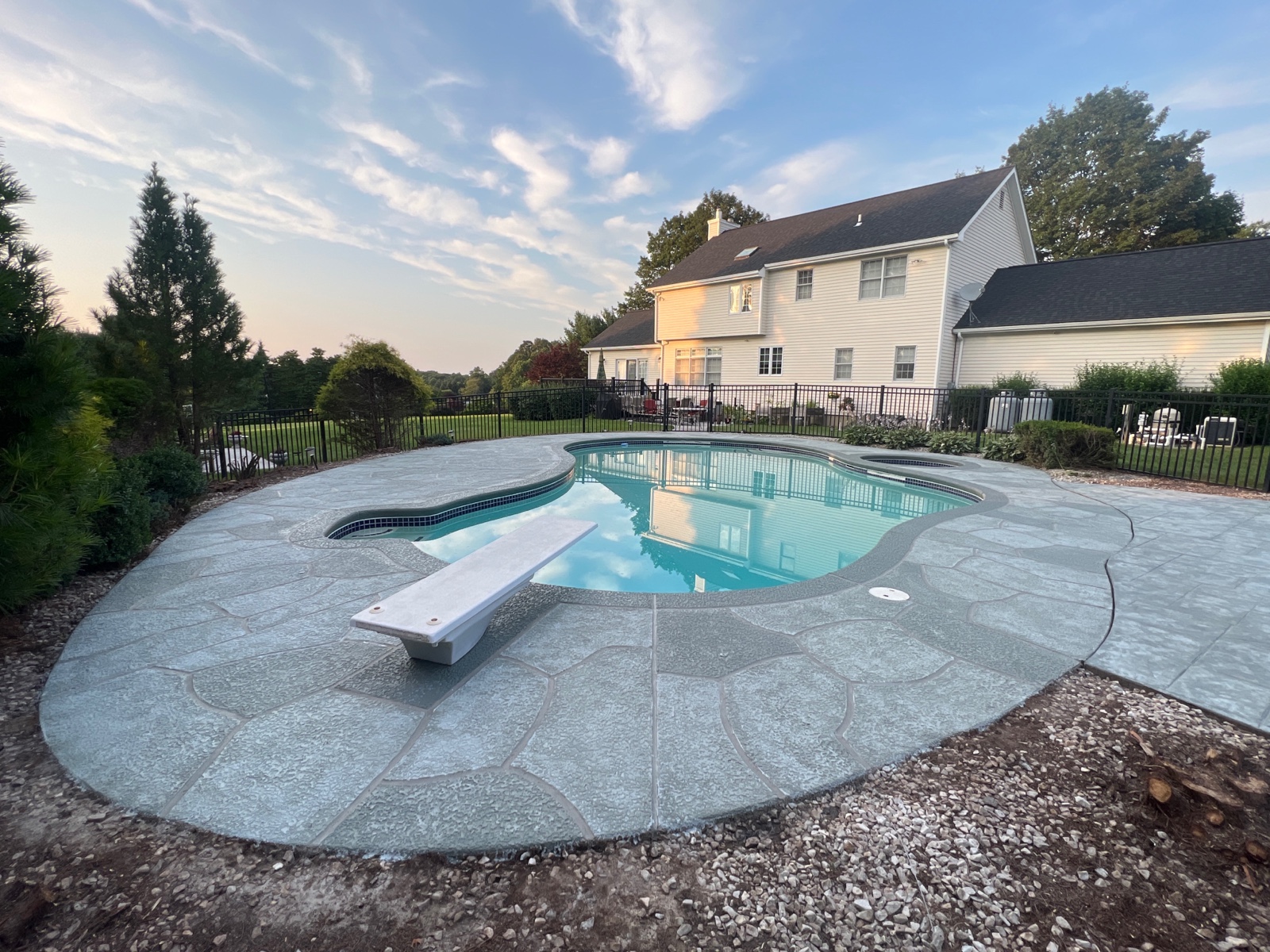Pool deck resurfaced in Granite Boulder finish with natural boulder-inspired appearance