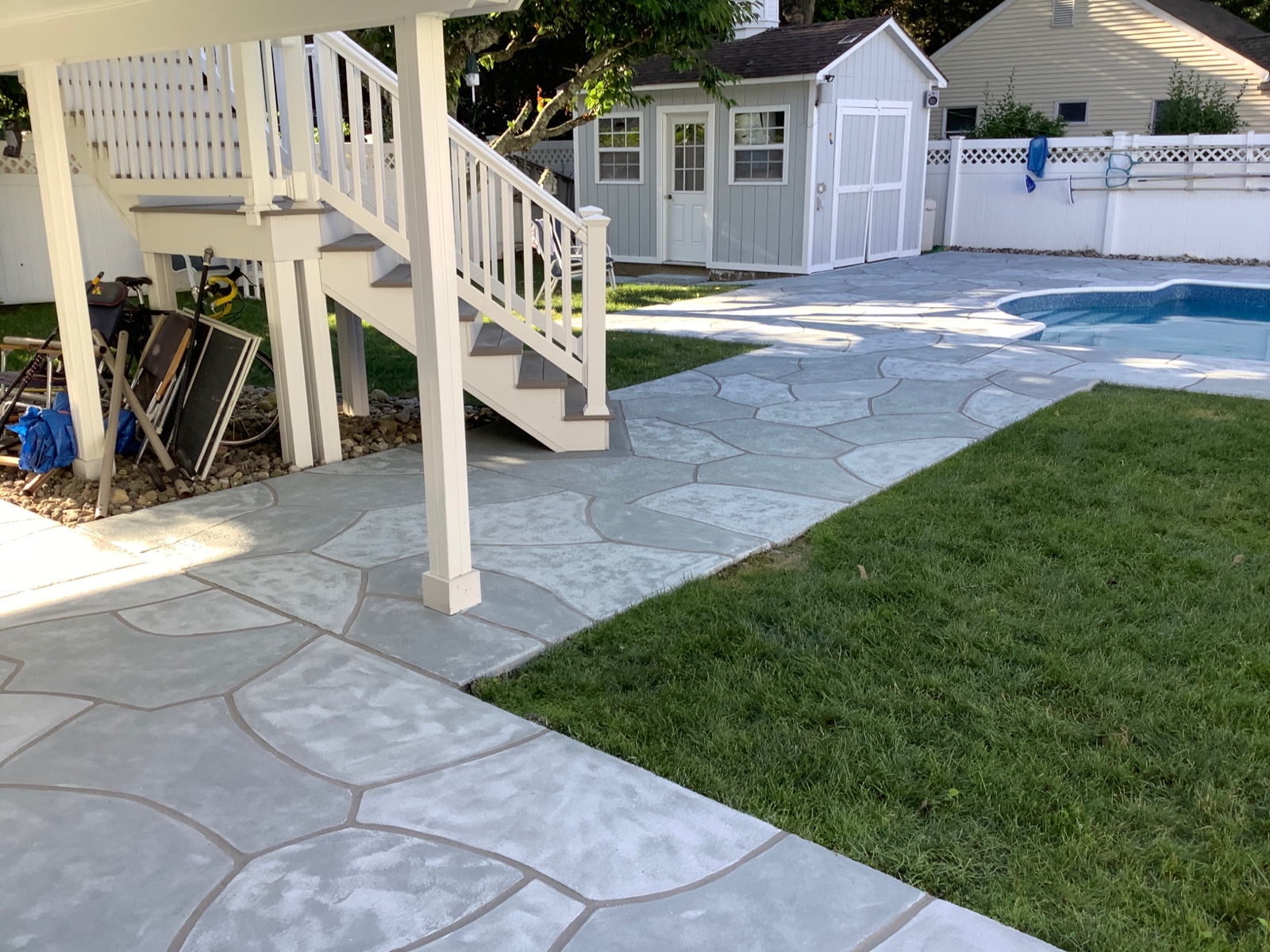 Granite Boulder decorative concrete pool deck resurfacing with warm natural stone appearance
