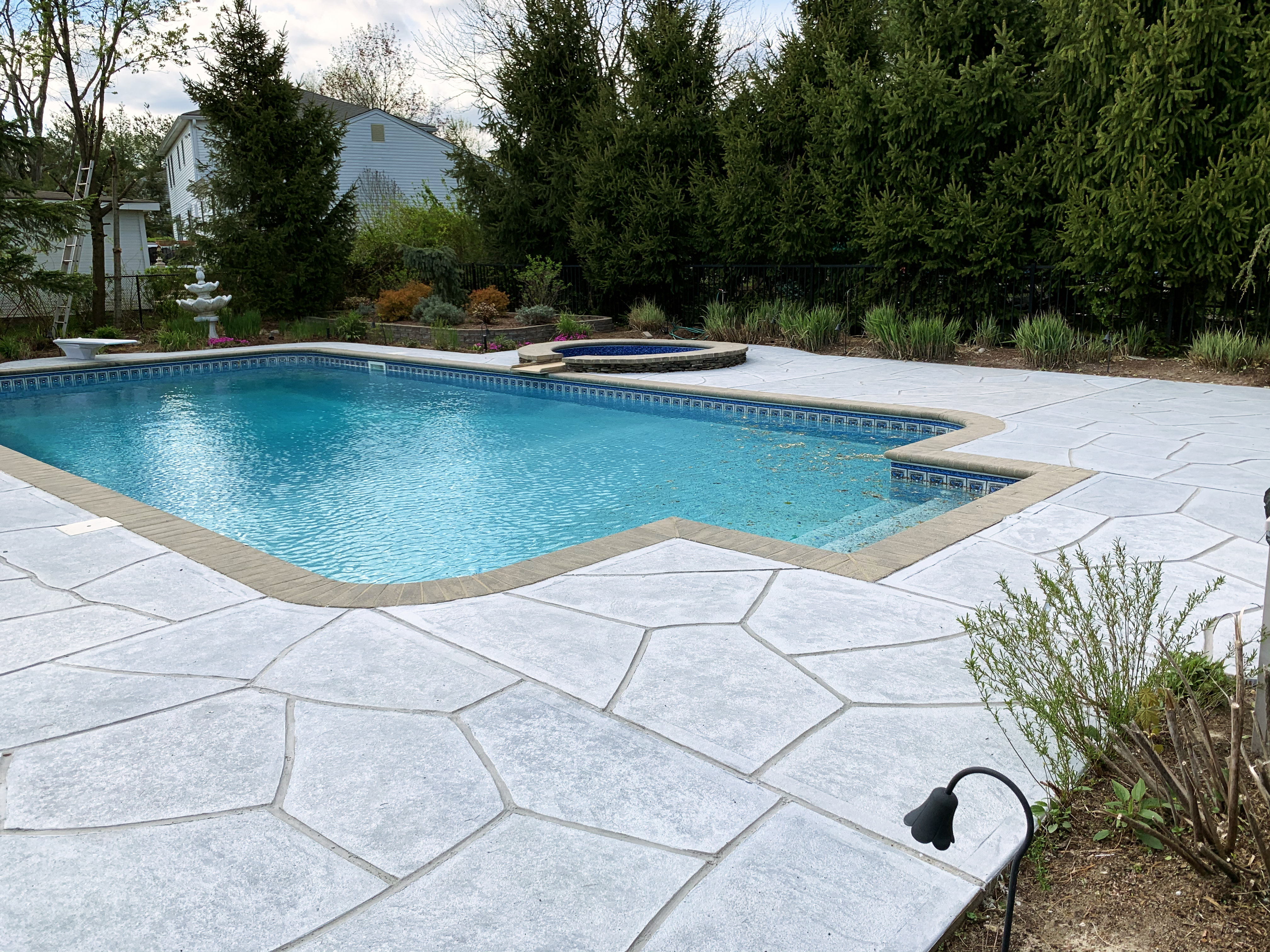 Granite Boulder pool deck renovation displaying bold granite-style aesthetic in Newton, MA