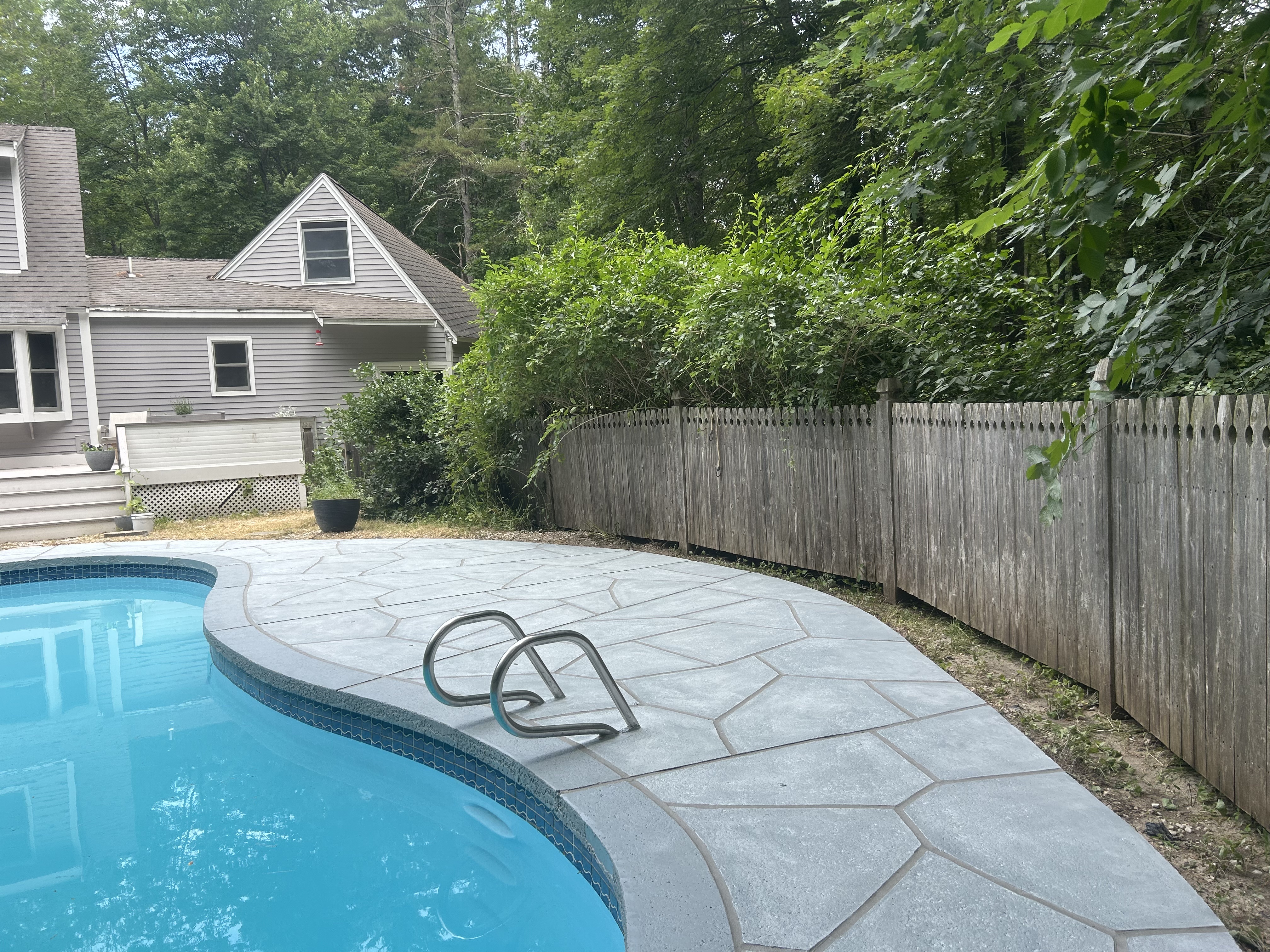 Granite Boulder pool deck renovation displaying durable resurfaced concrete
