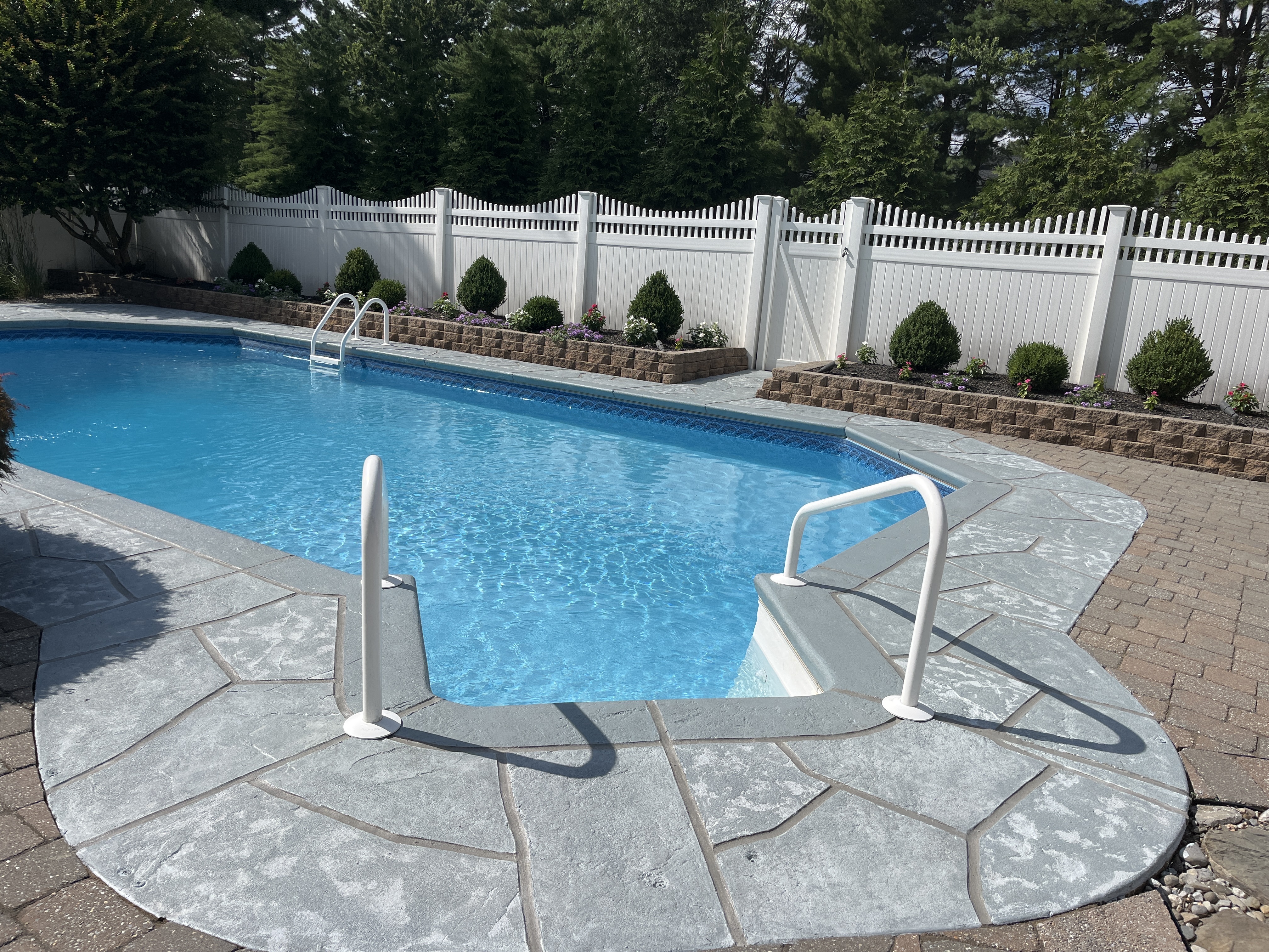 Granite Boulder pool deck renovation displaying durable resurfaced concrete