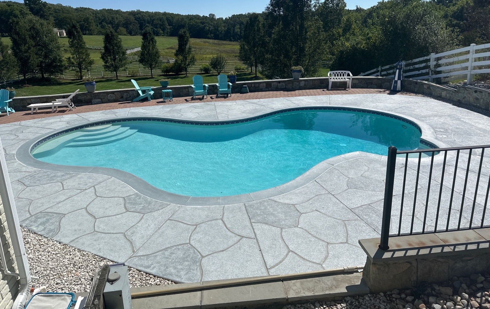 RenuKrete resurfaced pool deck in Granite Boulder showing durable resurfaced concrete