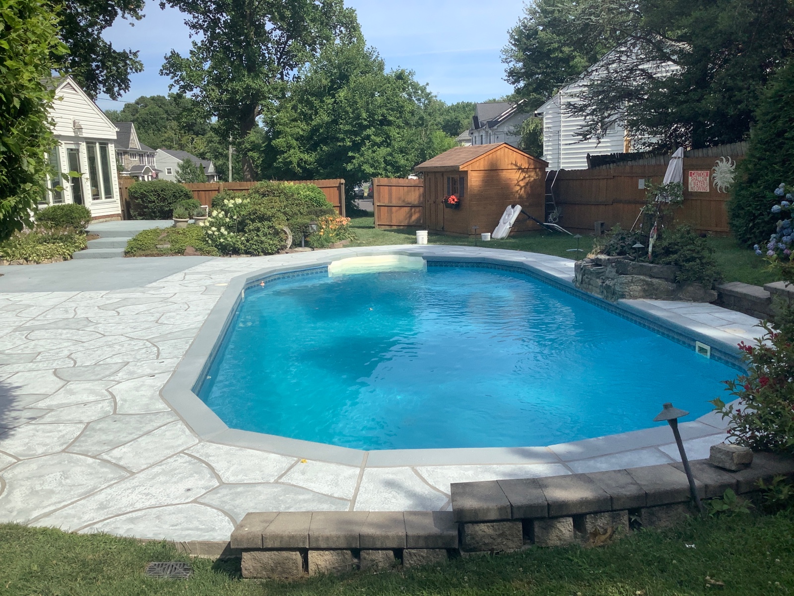 RenuKrete resurfaced pool deck in Granite Boulder showing bold granite-style aesthetic in Princeton, NJ