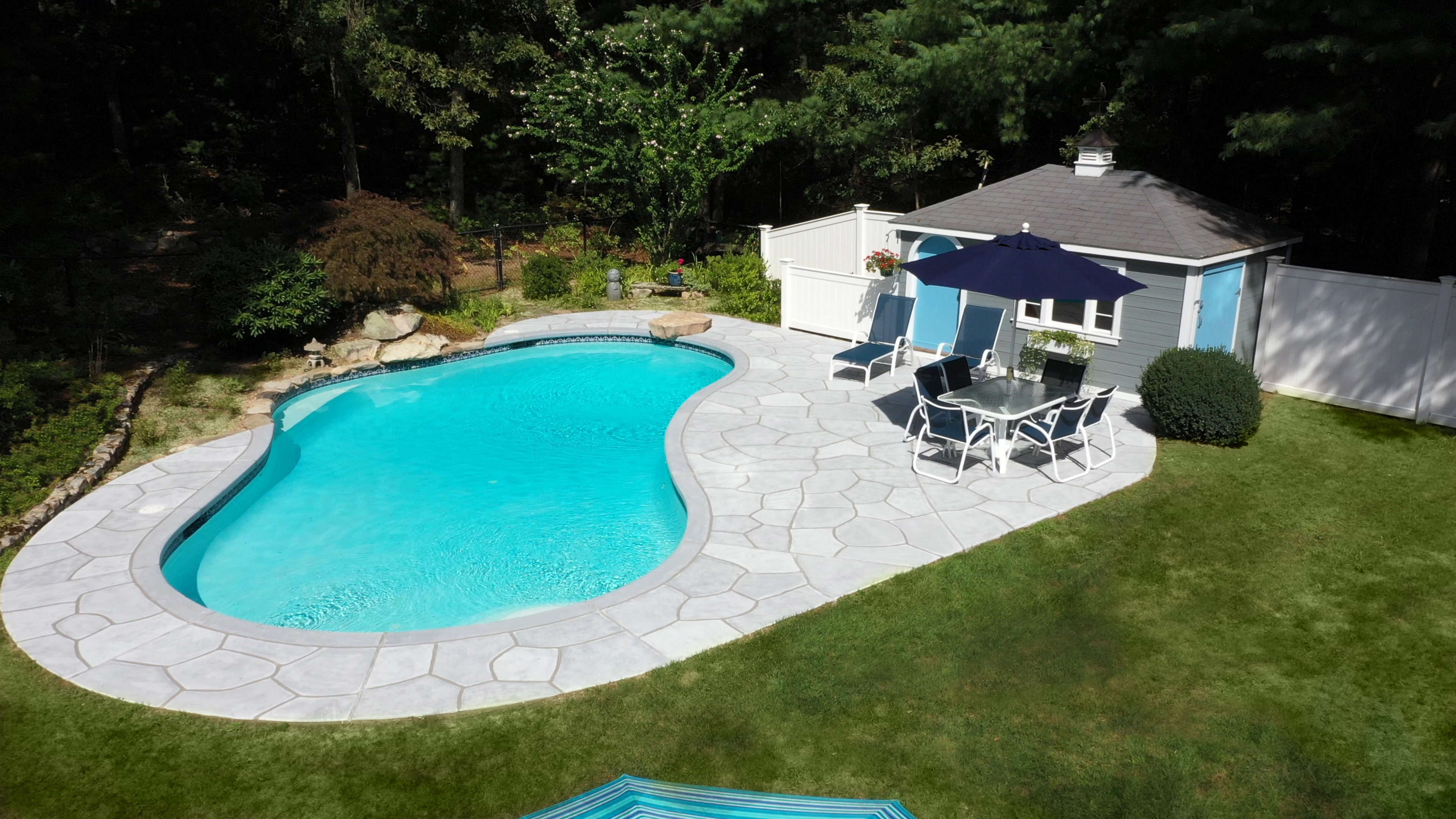 Granite Boulder pool deck renovation displaying deep gray granite tones