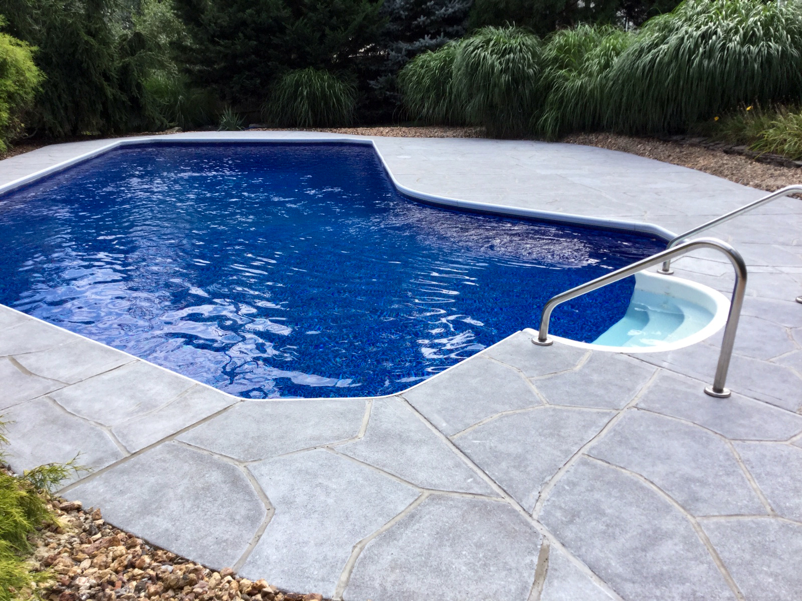 Granite Boulder pool deck renovation displaying bold granite-style aesthetic