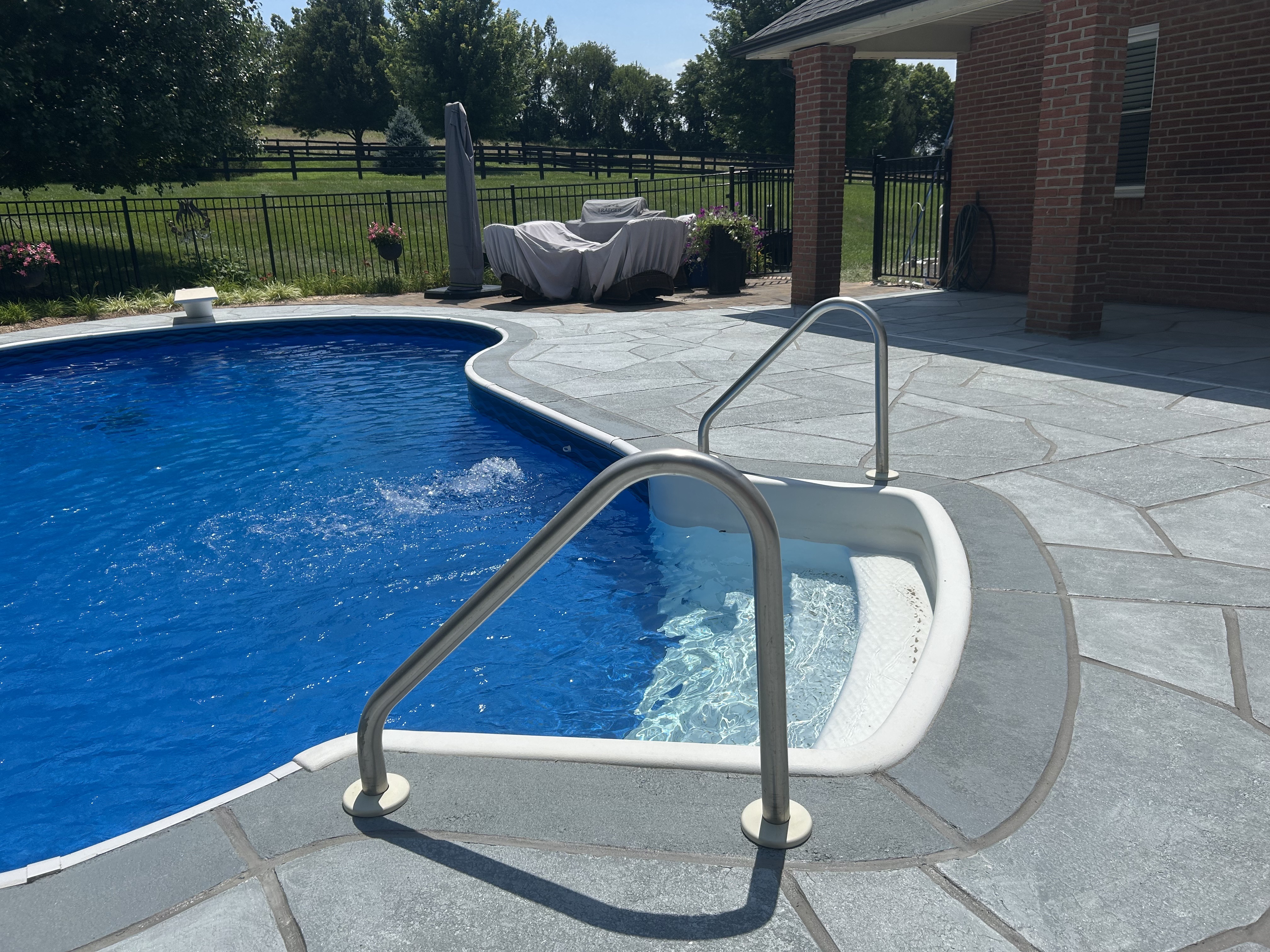 Granite Boulder pool deck concrete resurfacing project with refined slate like texture.