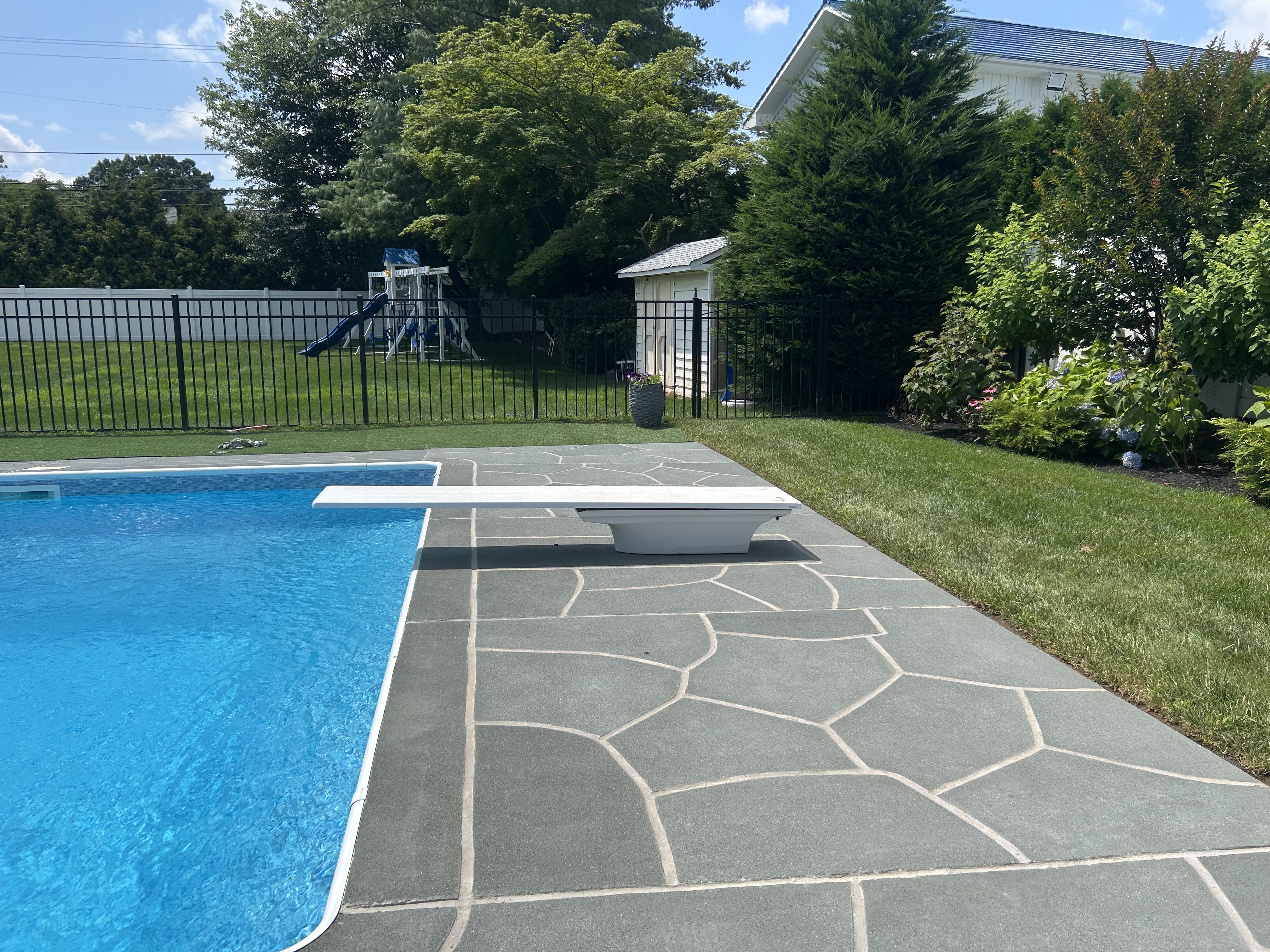 Upgraded concrete pool deck in Granite Slate finish in Marlton, NJ with clean gray slate look.