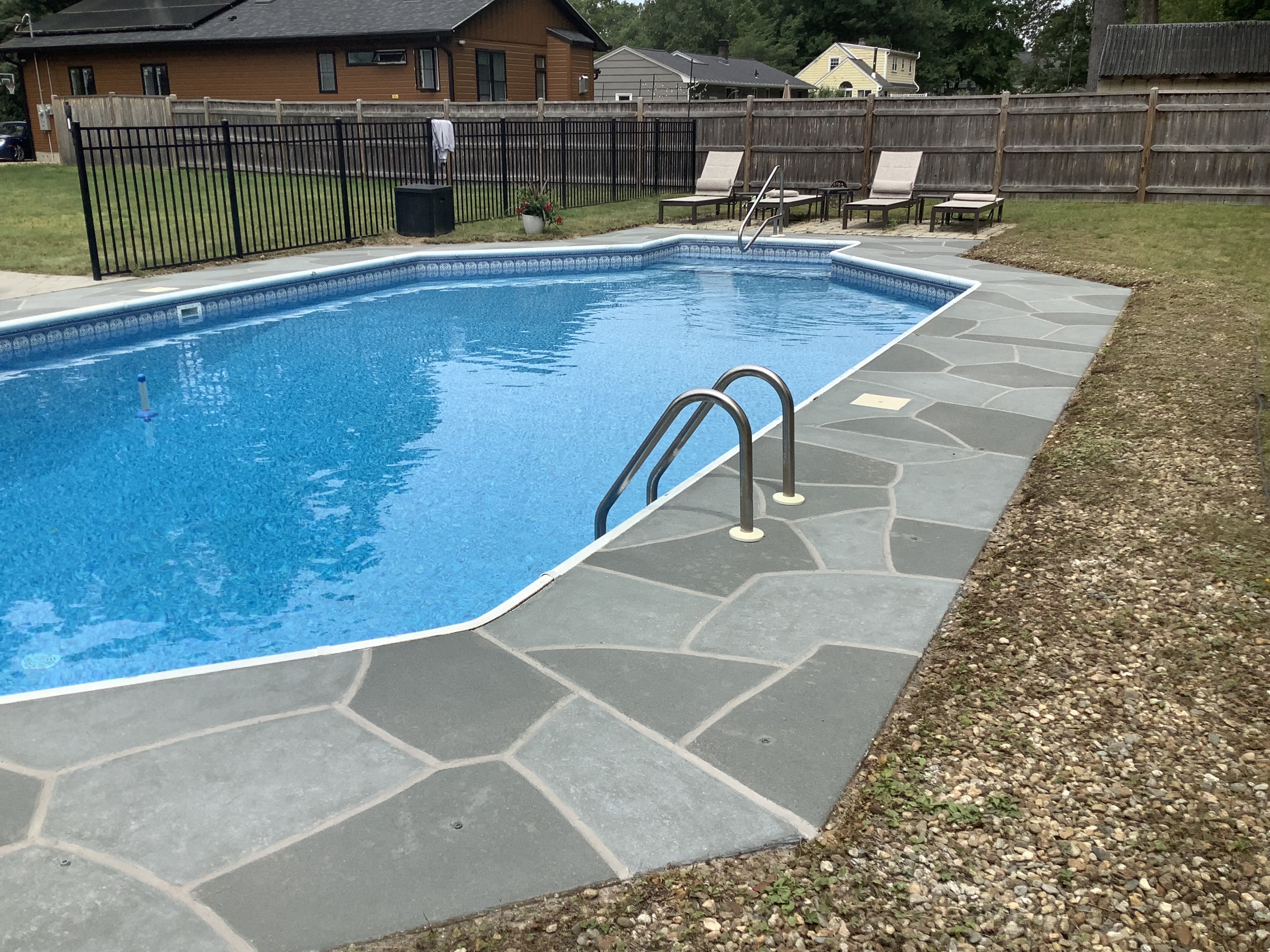 Upgraded concrete pool deck in Granite Slate finish with clean gray slate look.