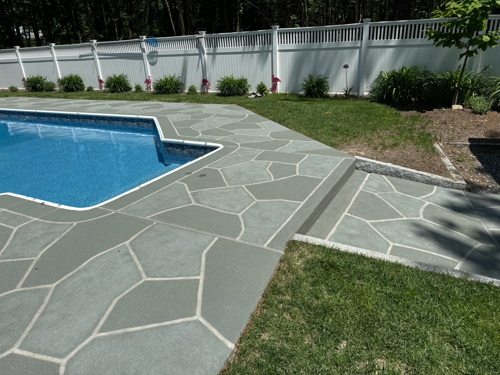 Concrete pool deck resurfaced in Granite Slate color theme with clean slate appearance