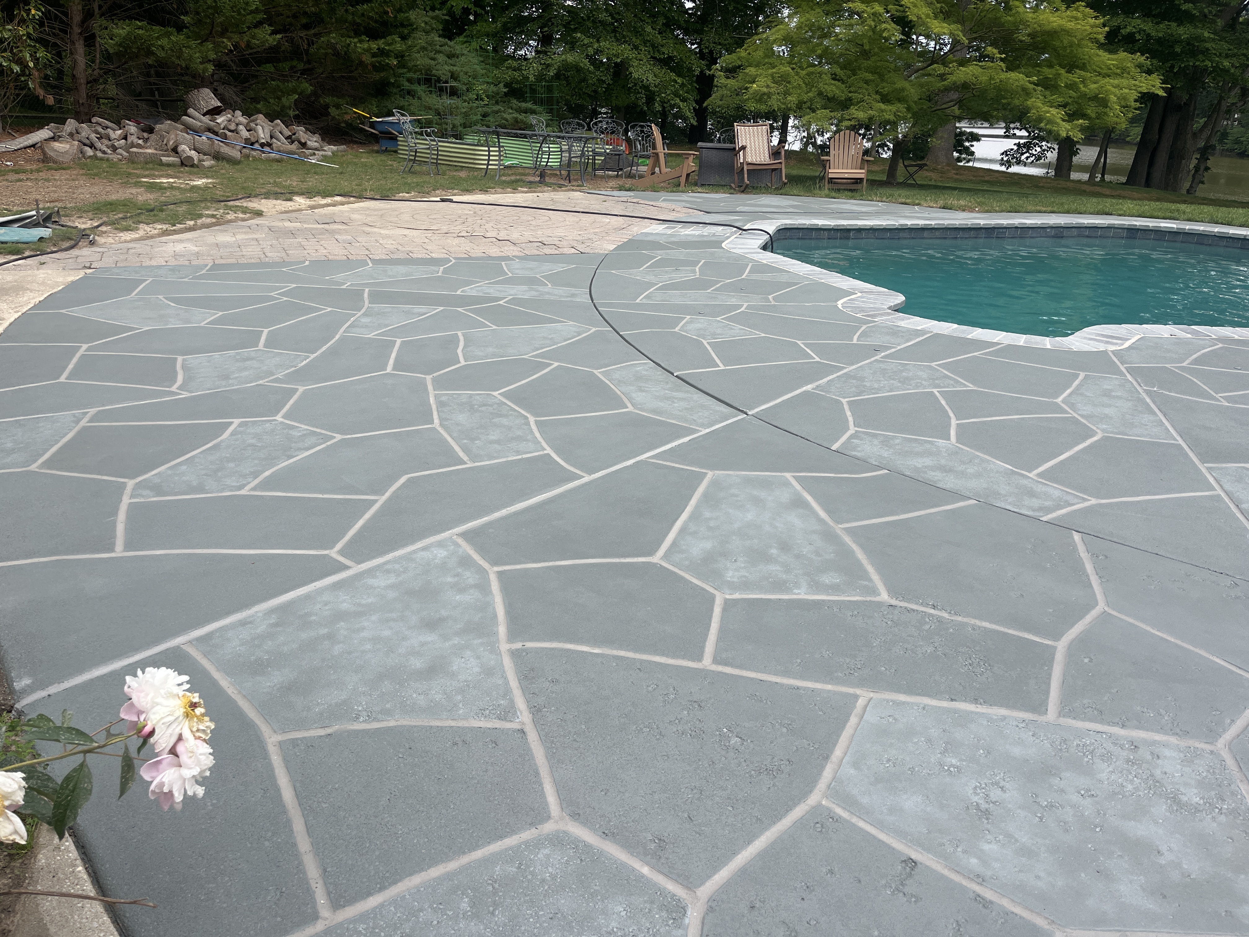 Upgraded concrete pool deck in Granite Slate finish with clean gray slate look.