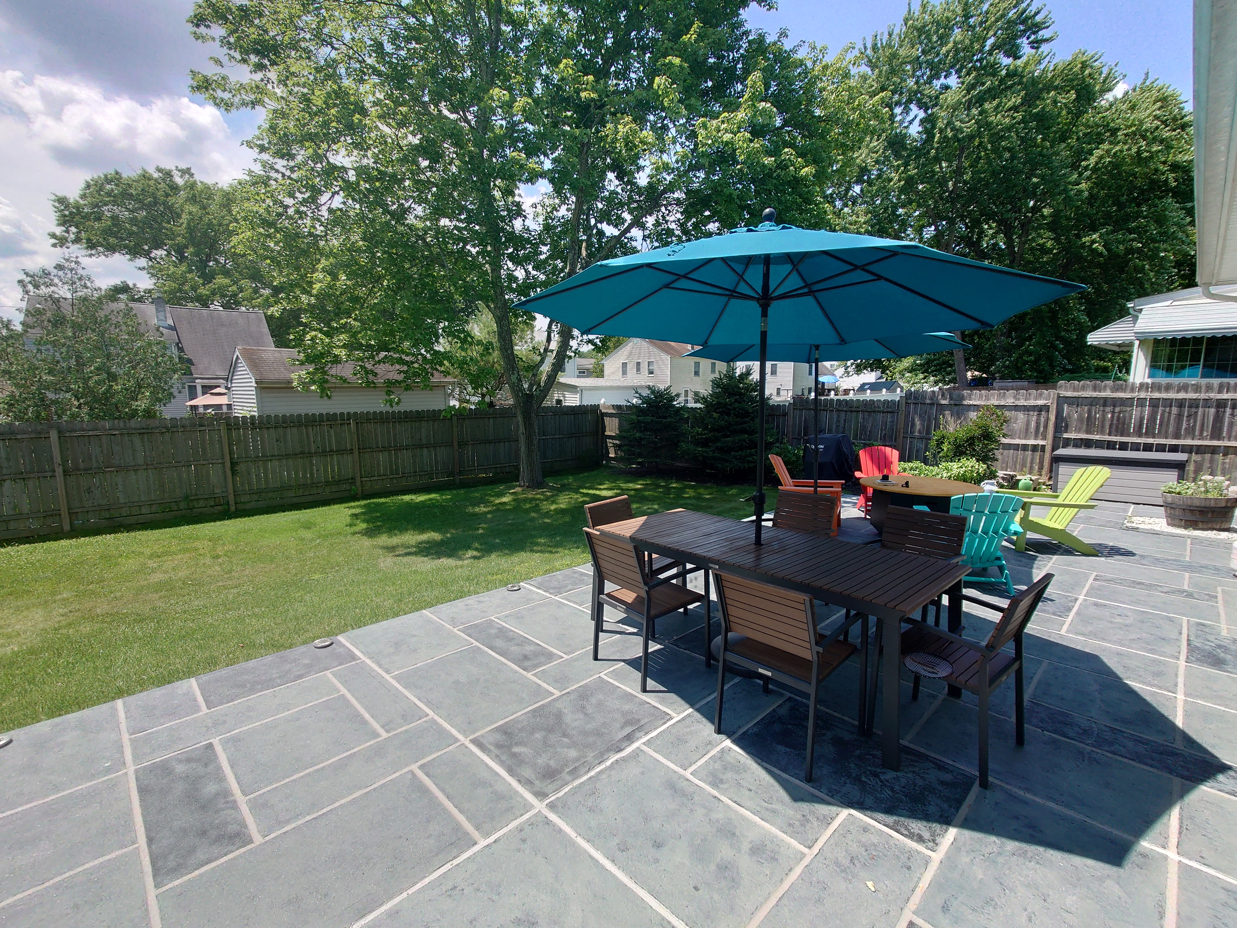 Residential pool deck in Granite Slate color theme after concrete resurfacing.