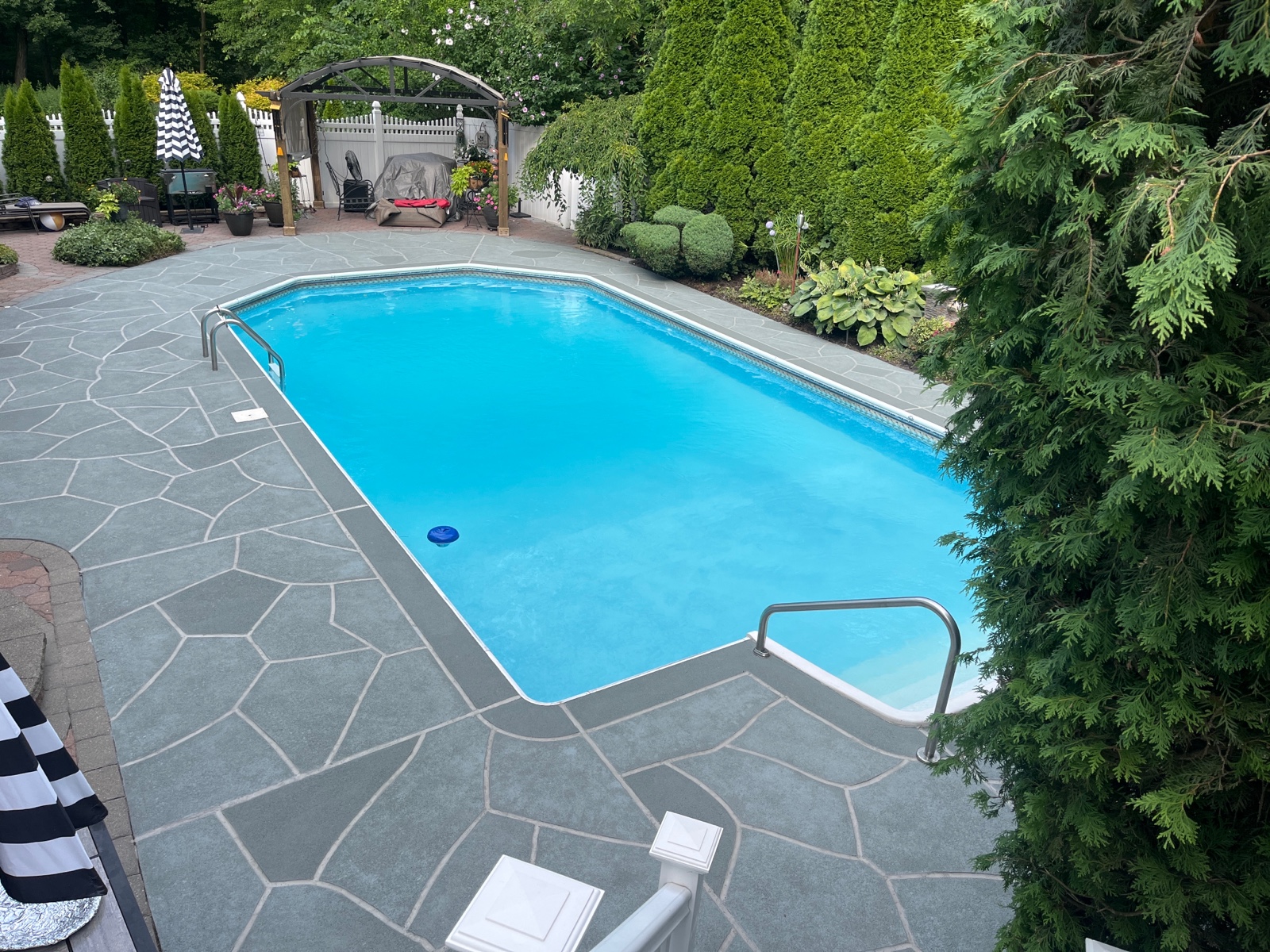 Residential pool deck in Granite Slate color theme in Annapolis, MD after concrete resurfacing.