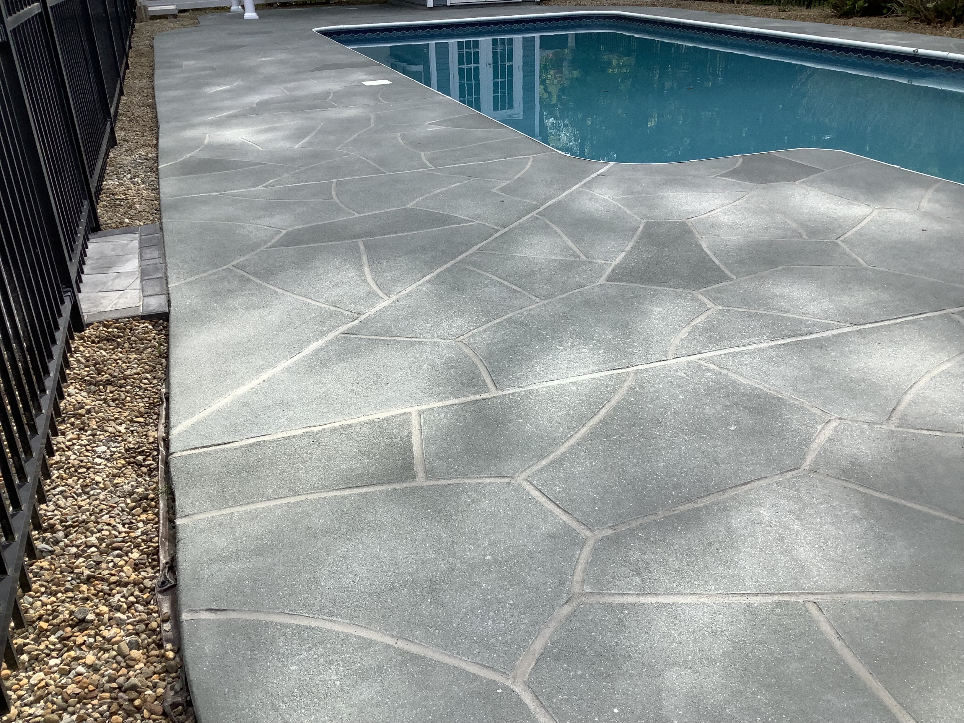 Residential pool deck in Granite Slate color theme after concrete resurfacing.