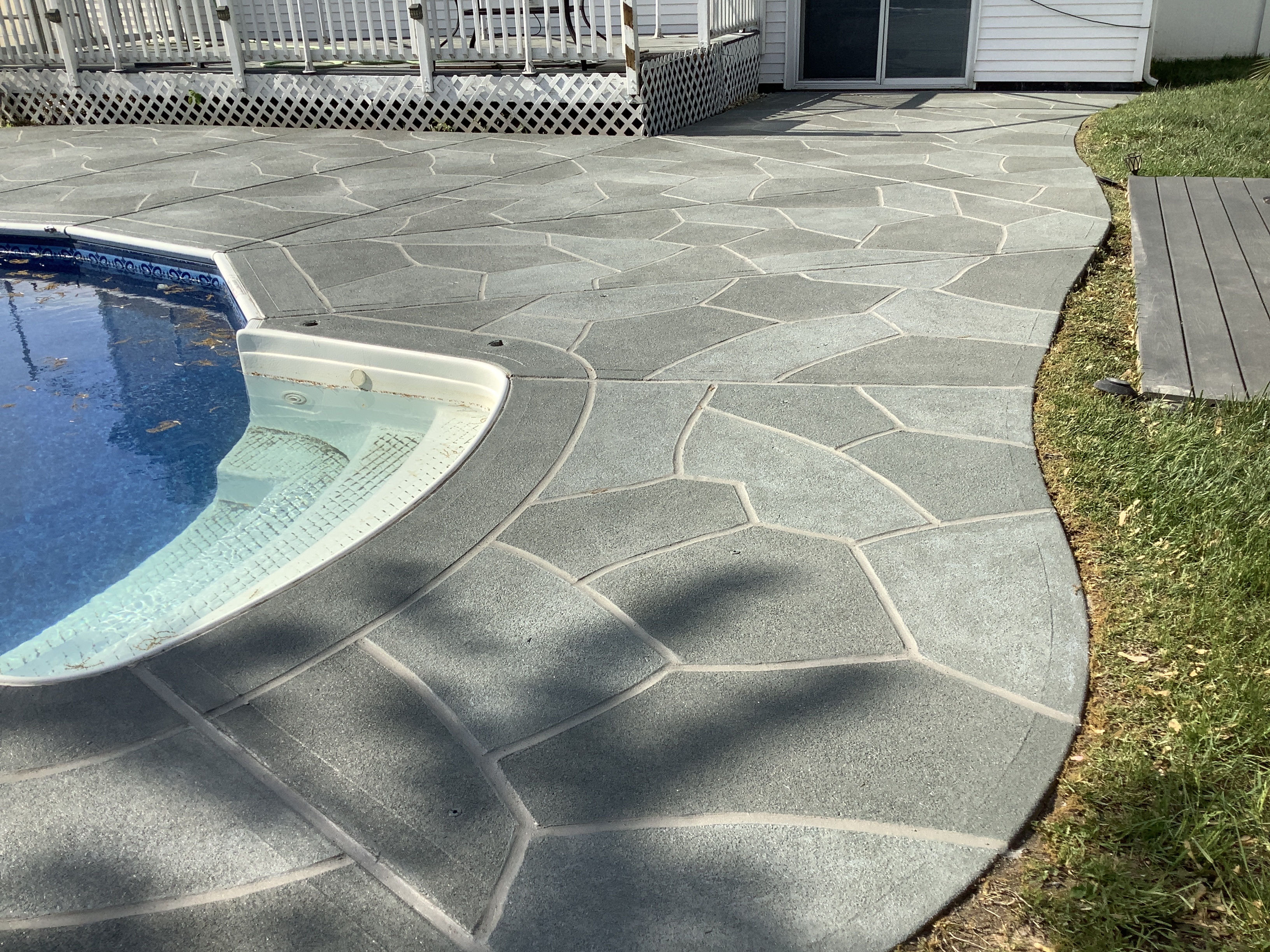 Residential pool deck in Granite Slate color theme in Plymouth, MA after concrete resurfacing.