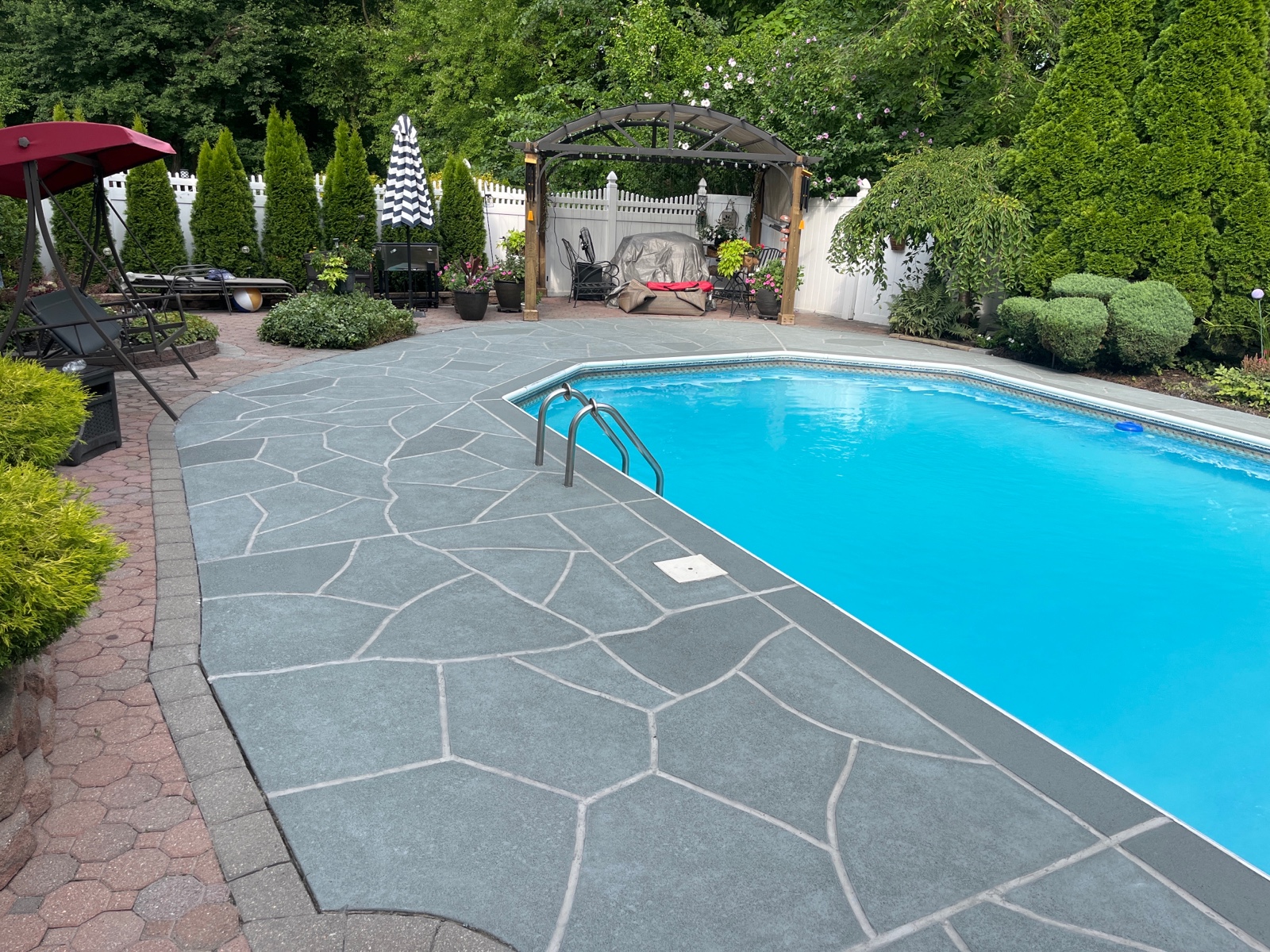 Upgraded concrete pool deck in Granite Slate finish with clean gray slate look.