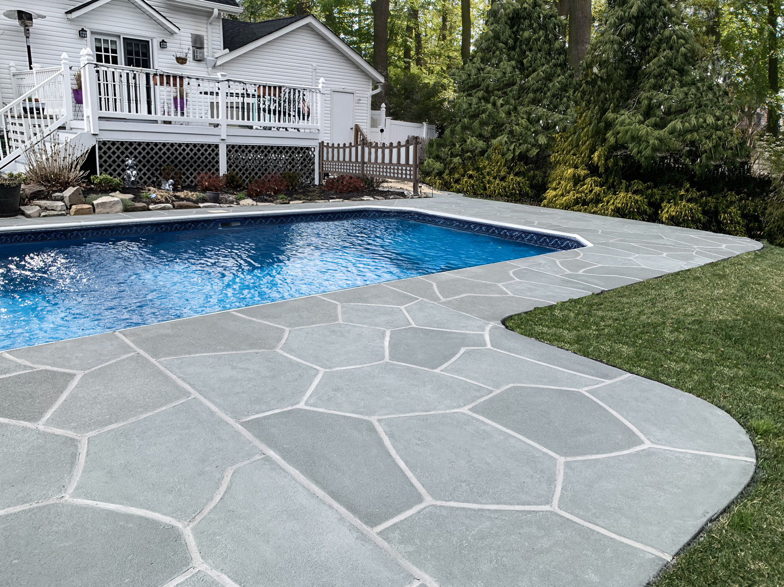Upgraded concrete pool deck in Granite Slate finish with a clean gray slate look.