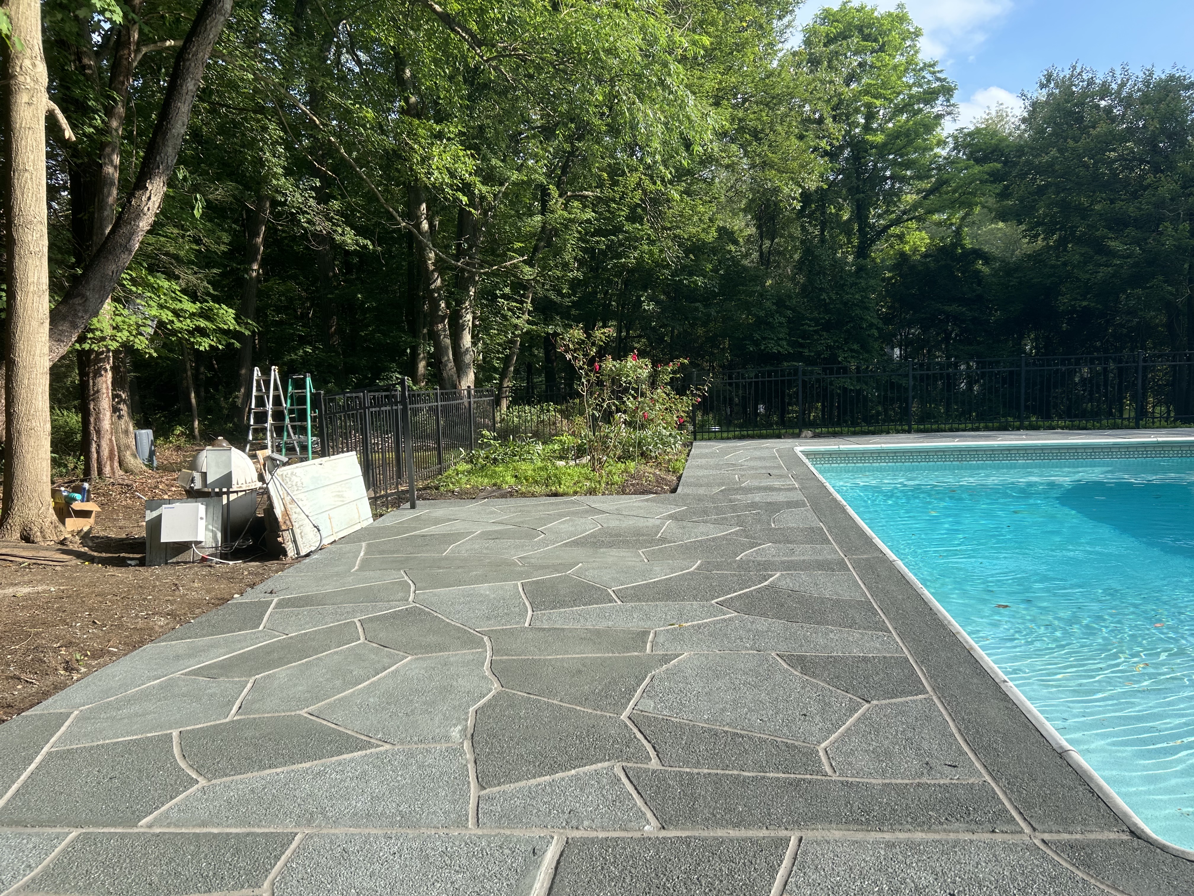 Residential pool deck in Granite Slate color theme in Princeton, NJ after concrete resurfacing.