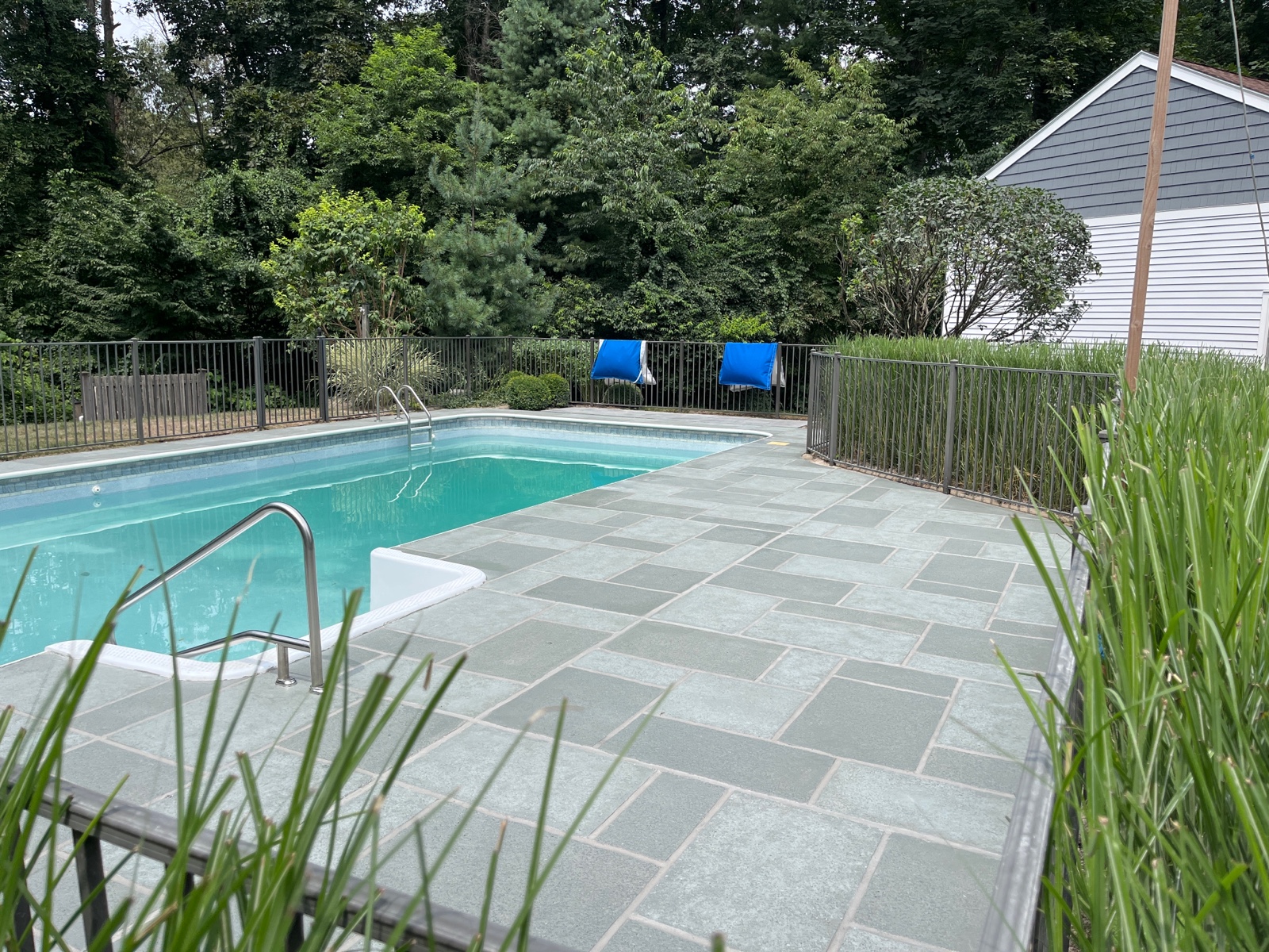 Concrete pool deck resurfaced in Granite Slate tile design with clean slate appearance