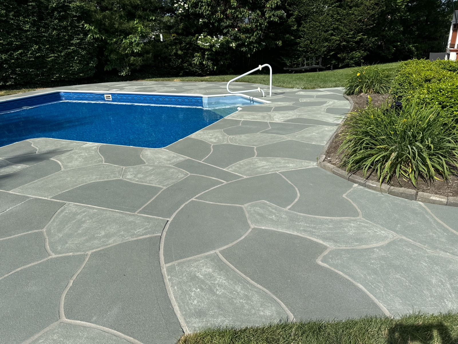 Upgraded concrete pool deck in Granite Slate finish with clean gray slate look.