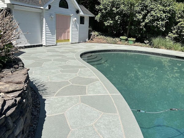 Upgraded concrete pool deck in Granite Slate finish with clean gray slate look.