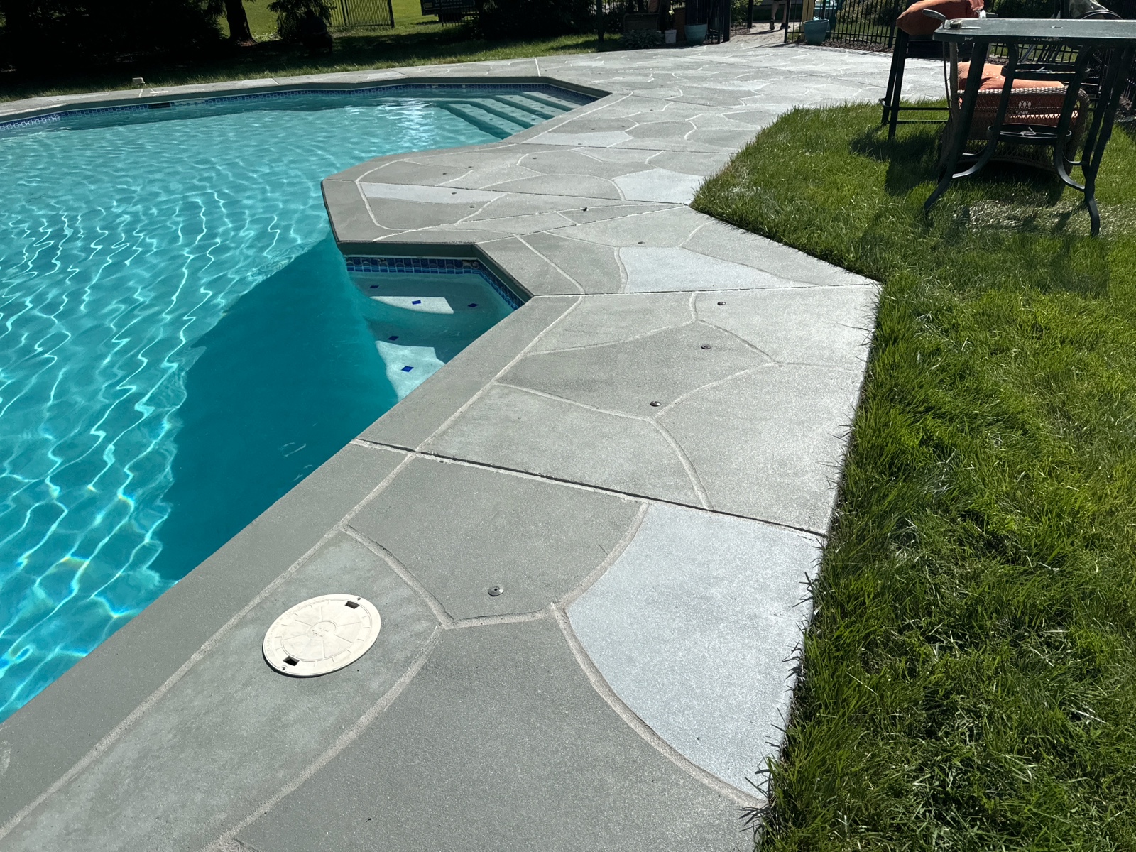 Resurfaced concrete pool deck in Granite Slate finish in Stamford, CT showing modern gray stone appearance.
