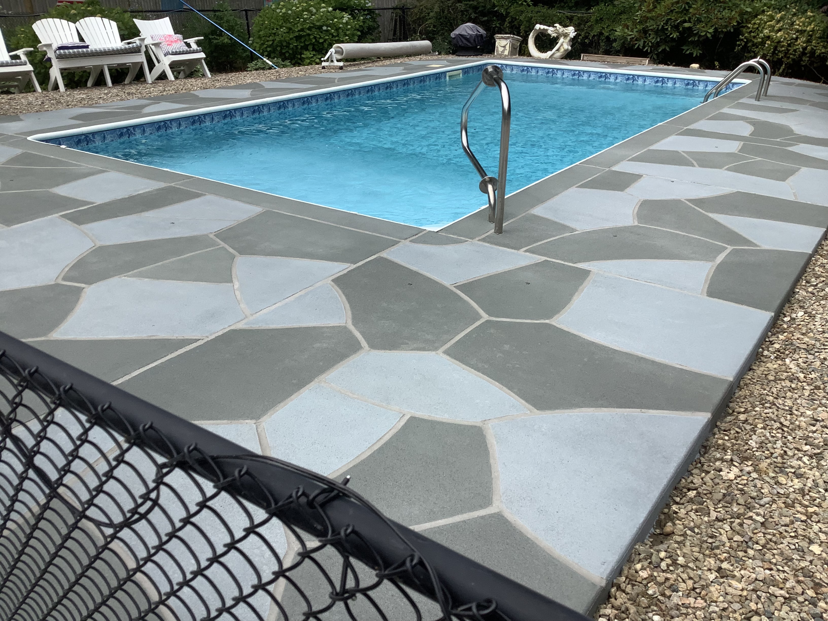 Resurfaced concrete pool deck in Granite Slate finish showing modern gray stone appearance.
