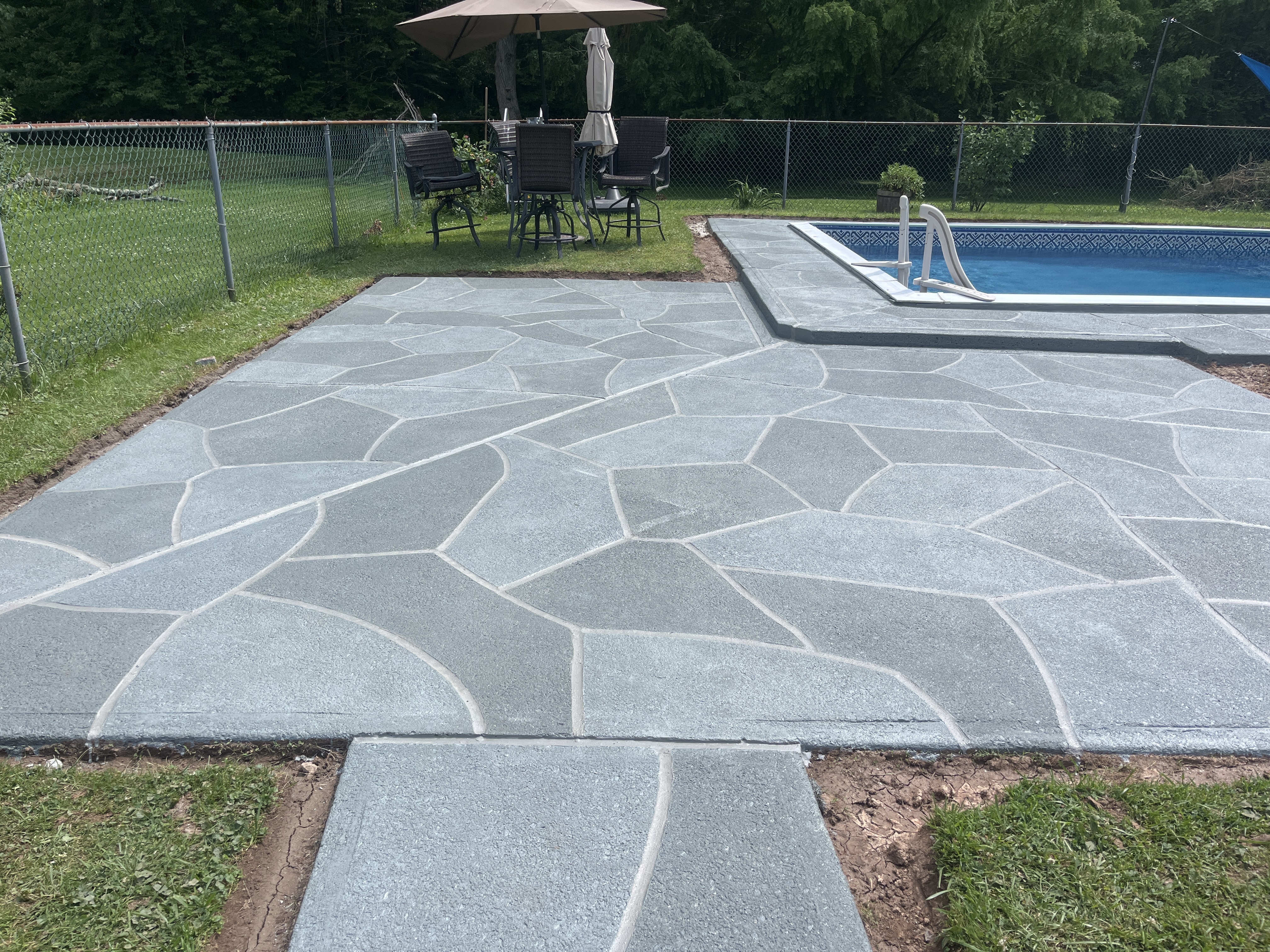 Granite Slate pool deck renovation displaying durable resurfaced concrete in Allentown, PA