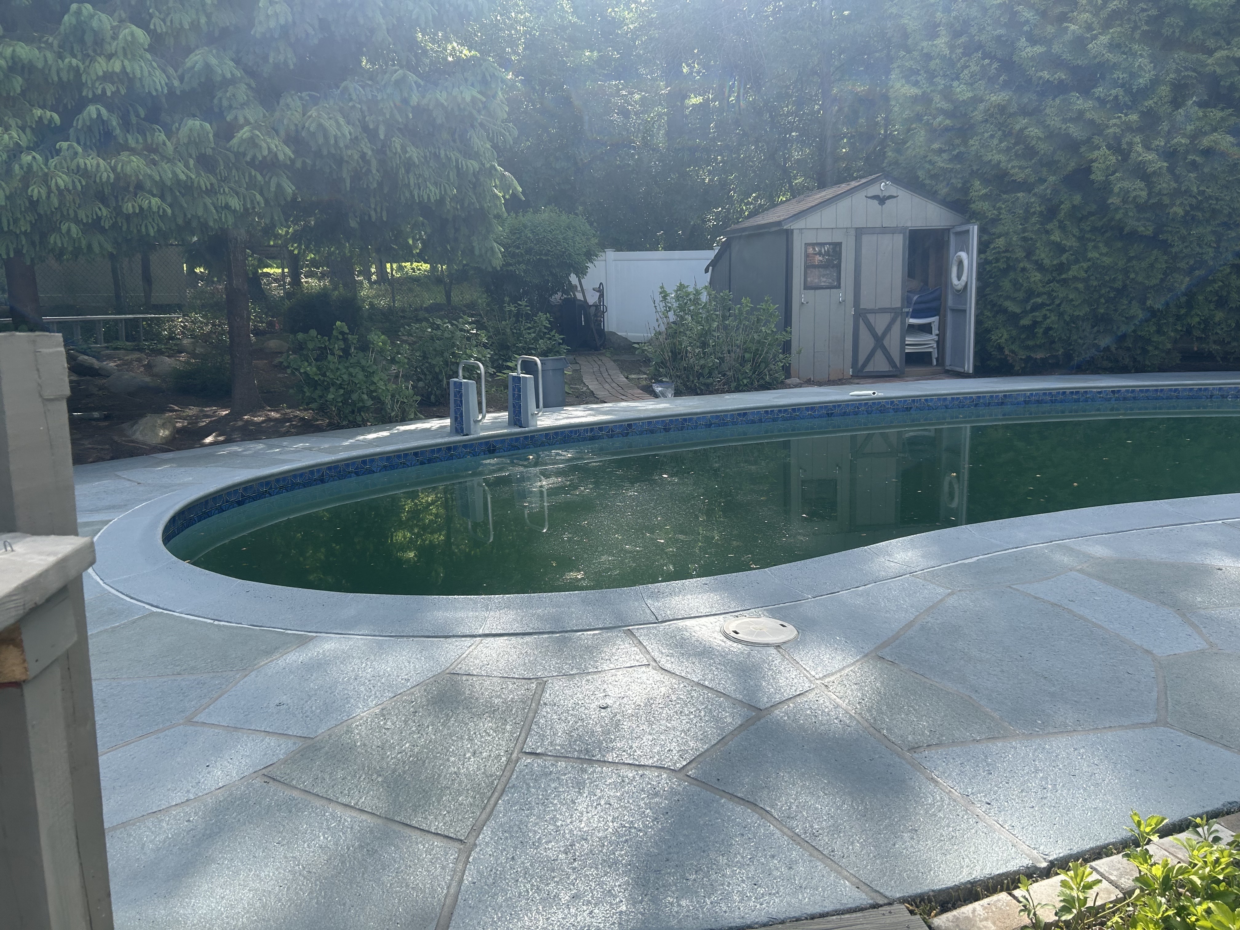 Residential pool deck in Granite Slate color theme after concrete resurfacing.