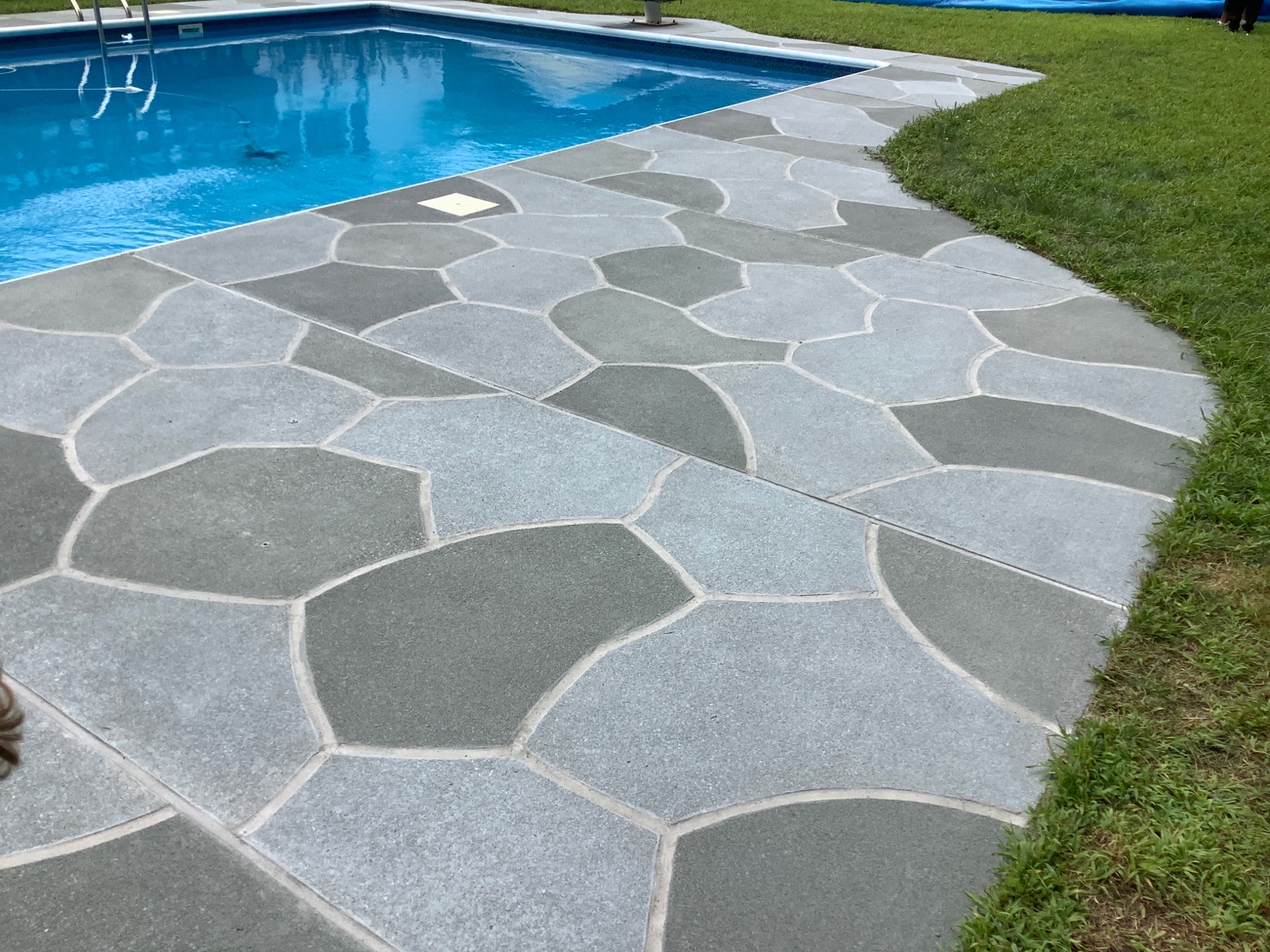 Upgraded concrete pool deck in Granite Slate finish with clean gray slate look.