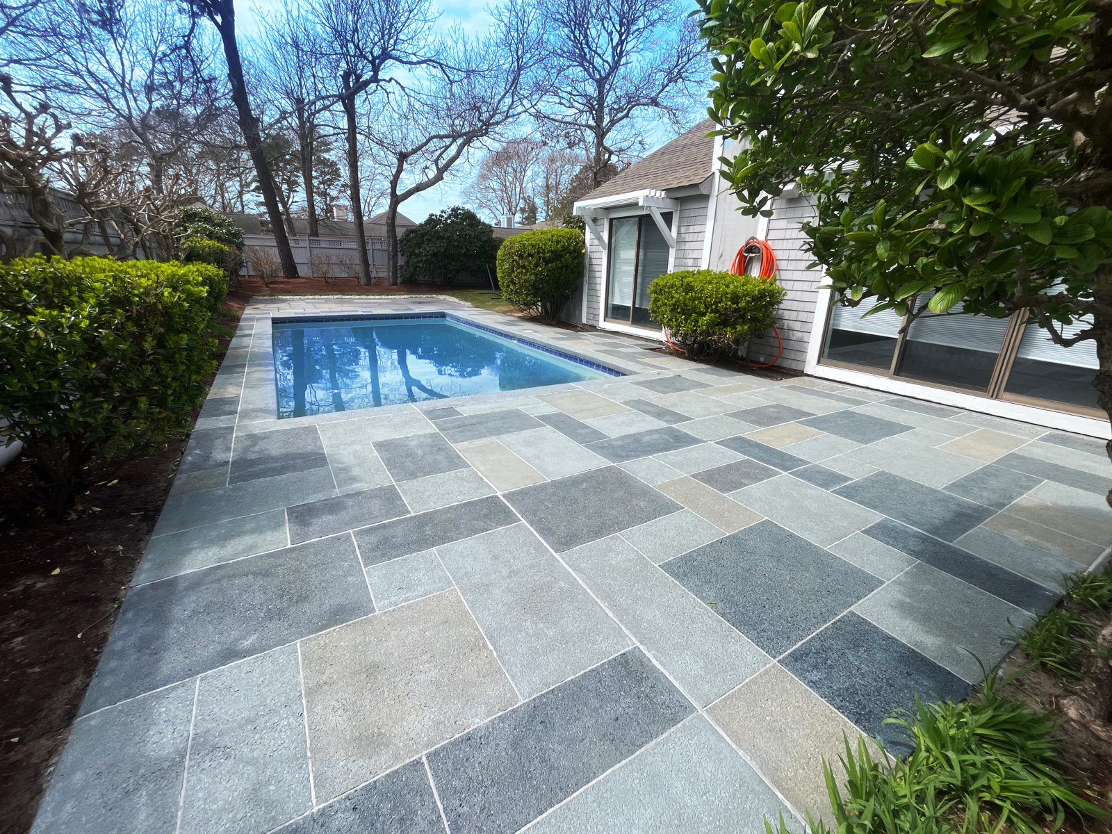 Resurfaced concrete pool deck in Granite Slate finish showing modern gray stone appearance.