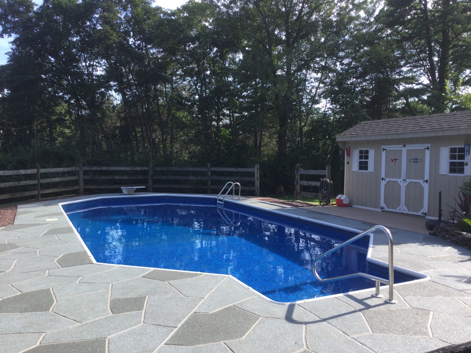 Resurfaced concrete pool deck in Granite Slate finish in Plymouth, MA showing modern gray stone appearance.