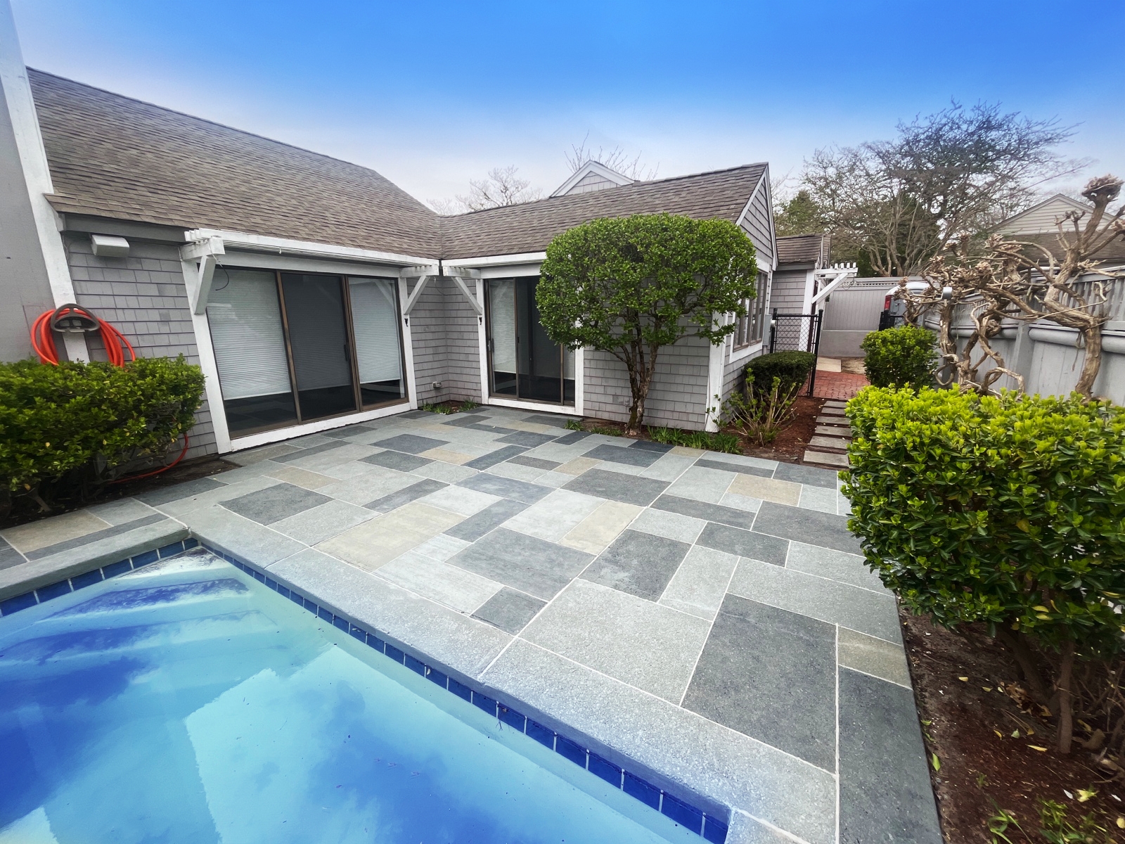 Upgraded concrete pool deck in Granite Slate finish with clean gray slate look.