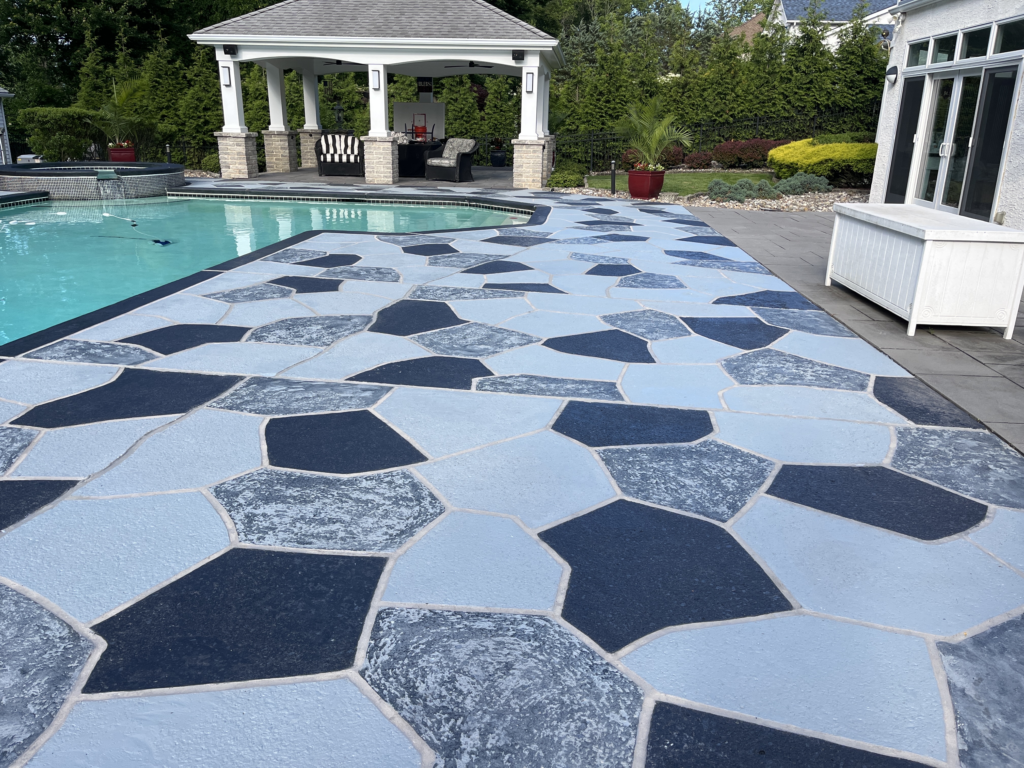 Residential pool deck in Granite Slate color theme in Stamford, CT after concrete resurfacing.