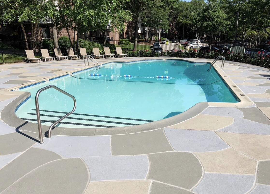 Upgraded concrete pool deck in Granite Slate finish with clean gray slate look.