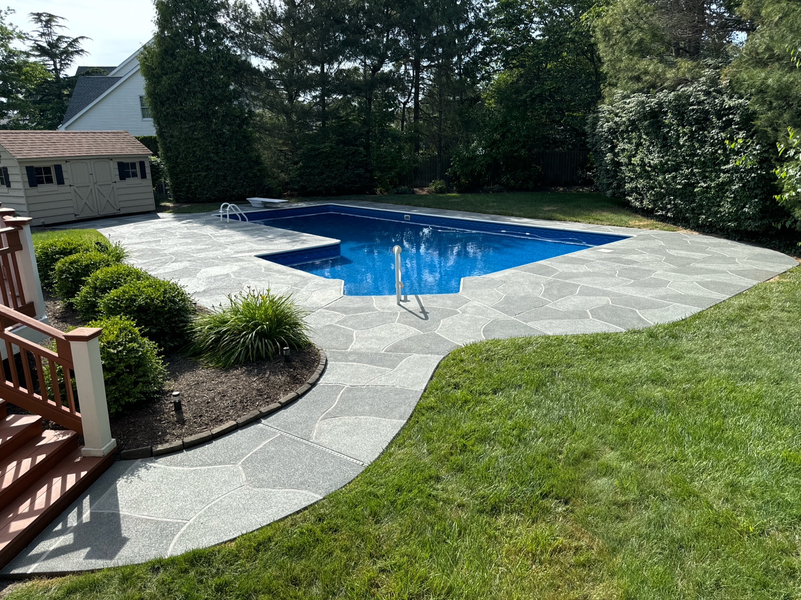 Residential pool deck in Granite Slate color theme after concrete resurfacing.