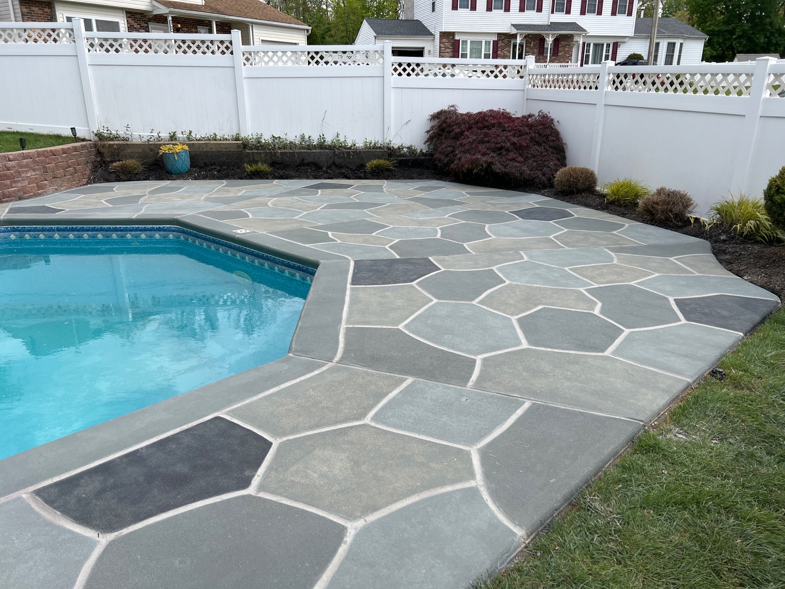 Upgraded concrete pool deck in Granite Slate finish with clean gray slate look.