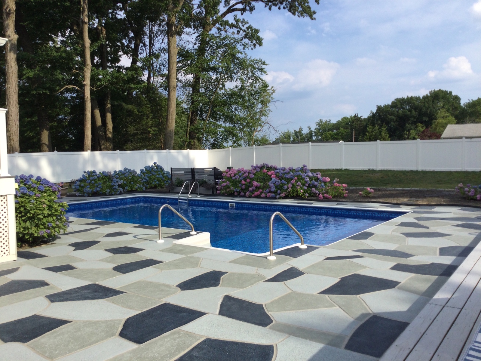 Residential pool deck in Granite Slate color theme after concrete resurfacing.