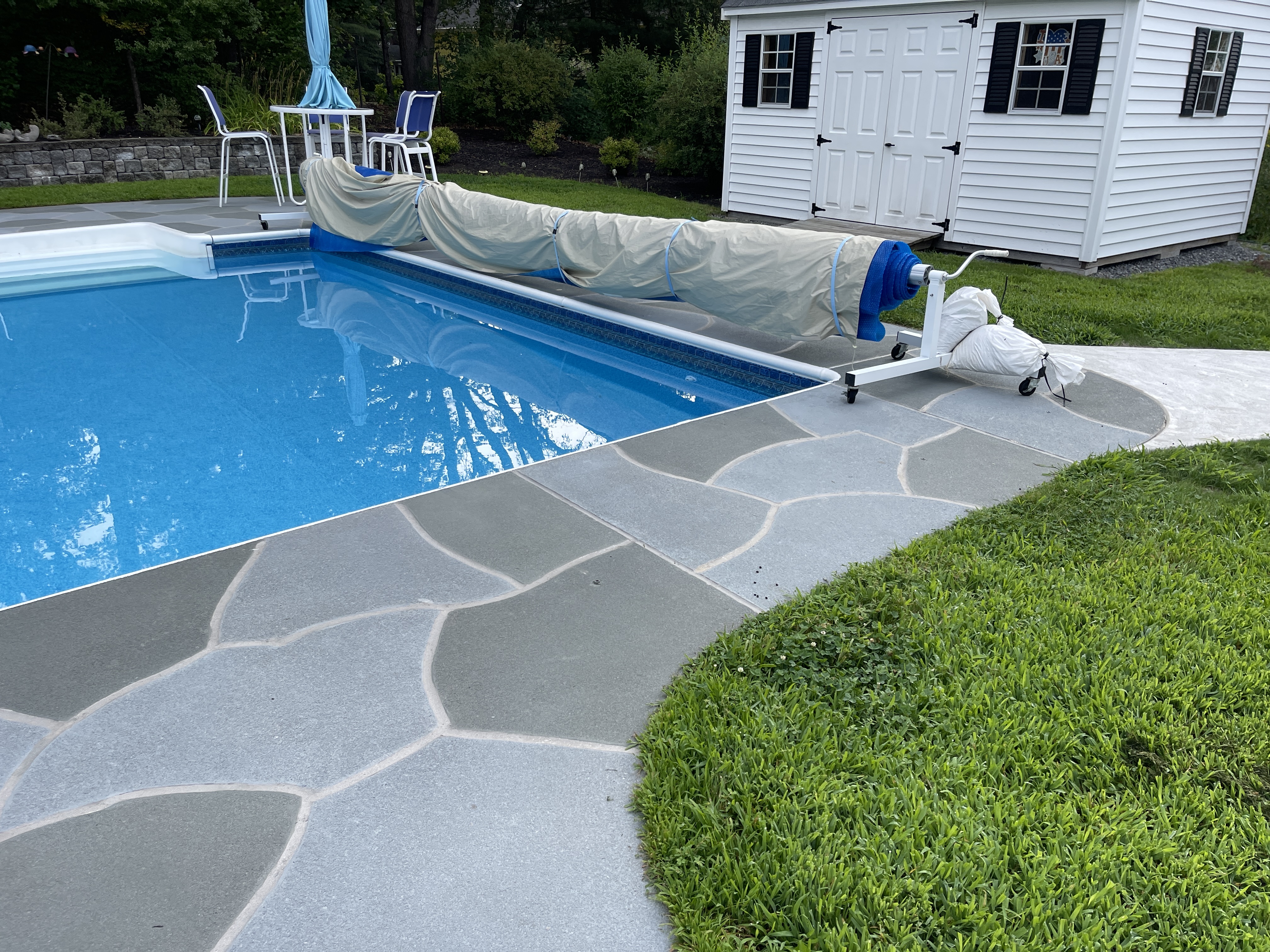 Resurfaced concrete pool deck in Granite Slate finish showing modern gray stone appearance.