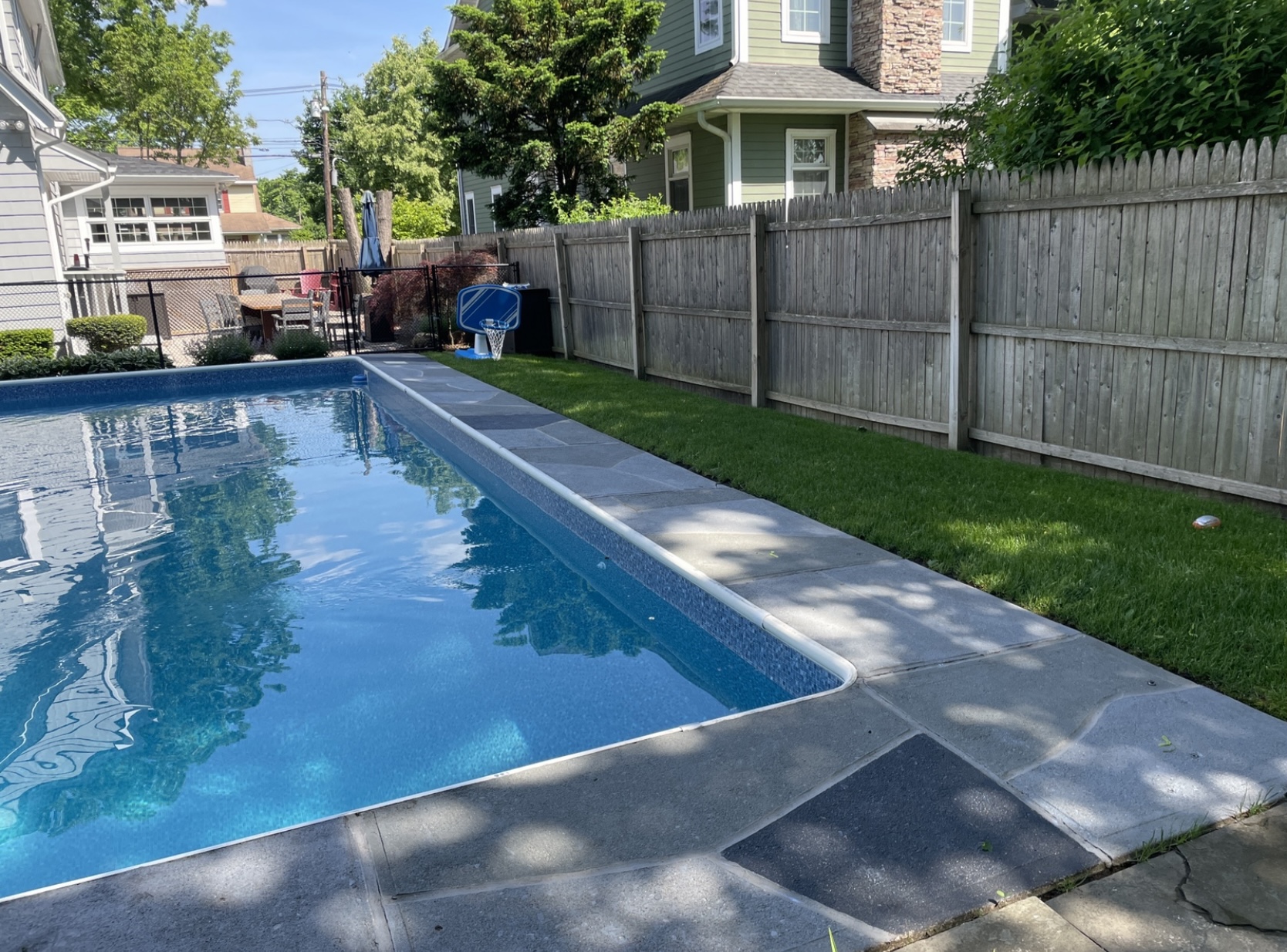 Upgraded concrete pool deck in Granite Slate finish with clean gray slate look.