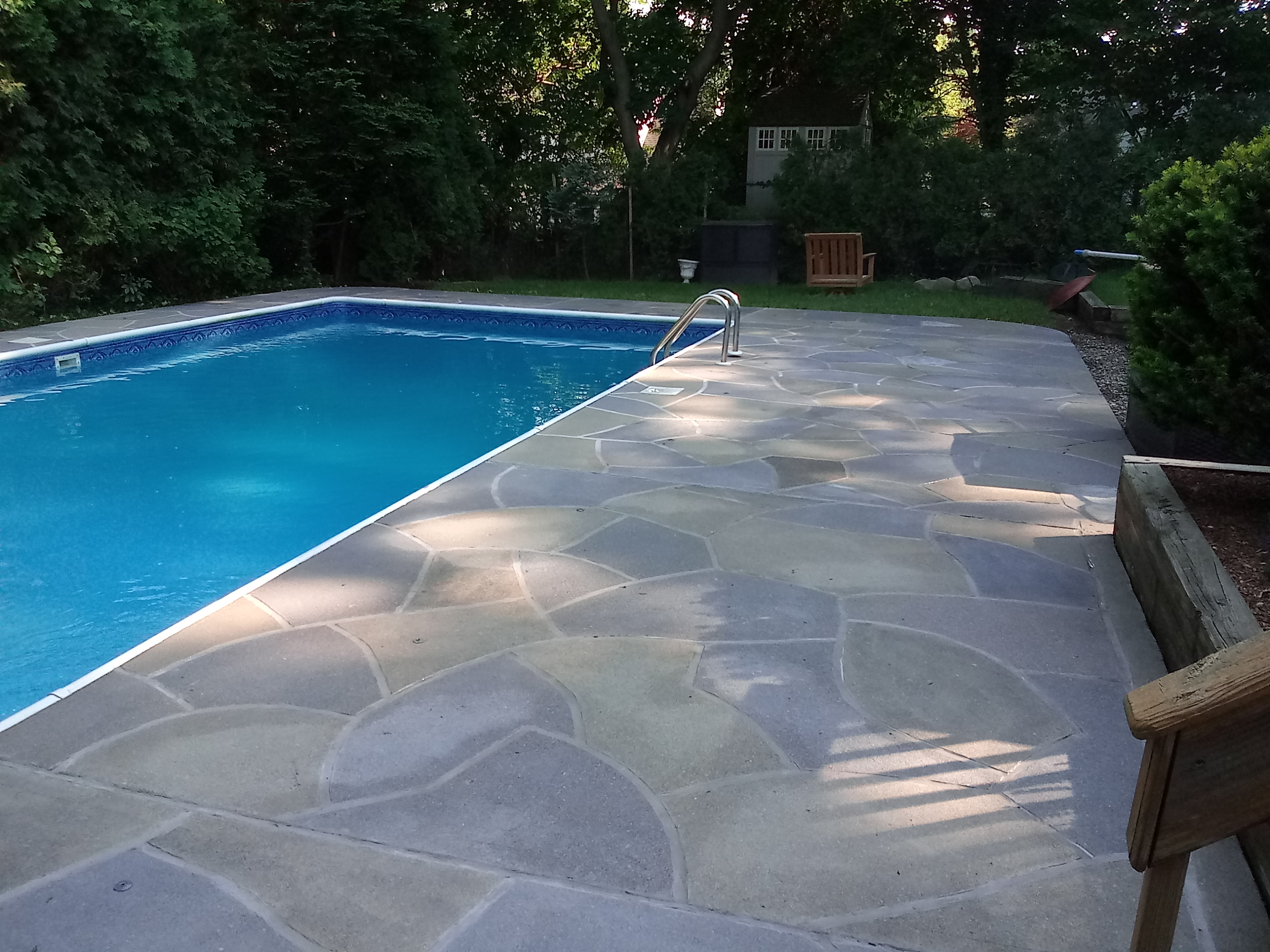 Residential pool deck in Granite Slate color theme after concrete resurfacing.